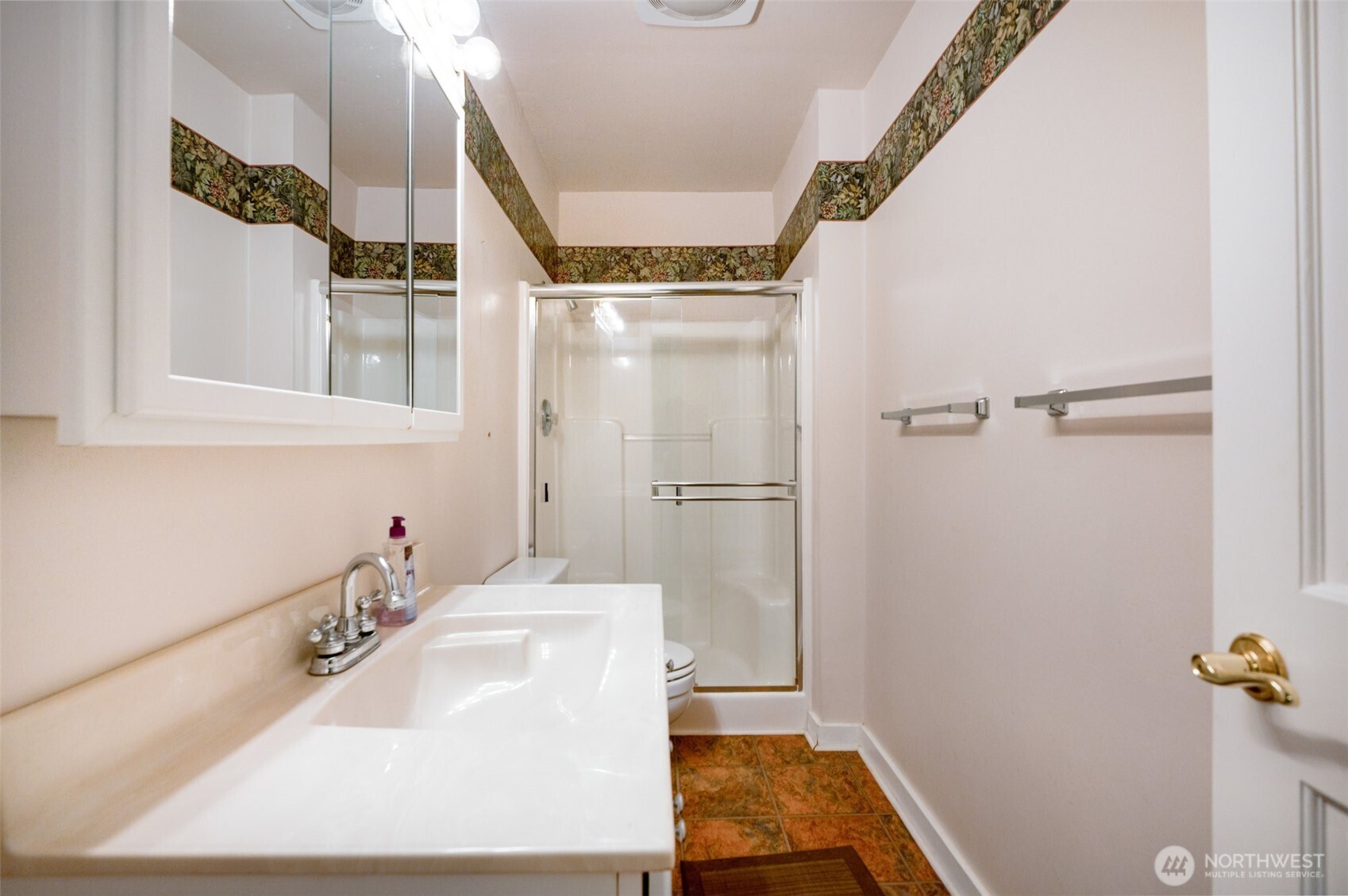 The downstairs bathroom offers convenient access from the bonus room, featuring a spacious layout and practical design ideal for guests or multi-level living.