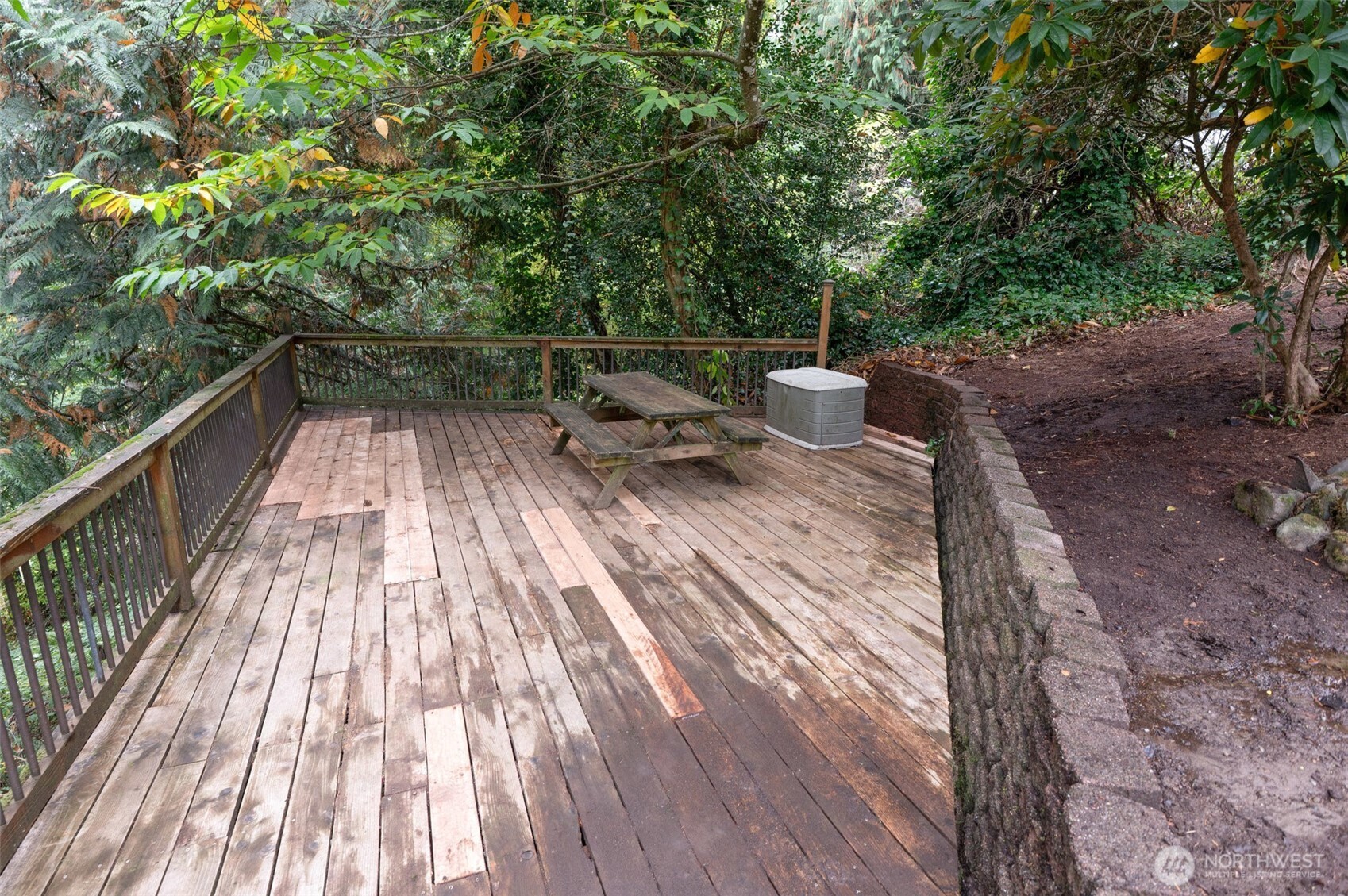 Stretching across the entire back of the home, the expansive deck invites you to take in breathtaking views of the mountains and Cottage Lake, with French door access from both the primary bedroom and dining area.