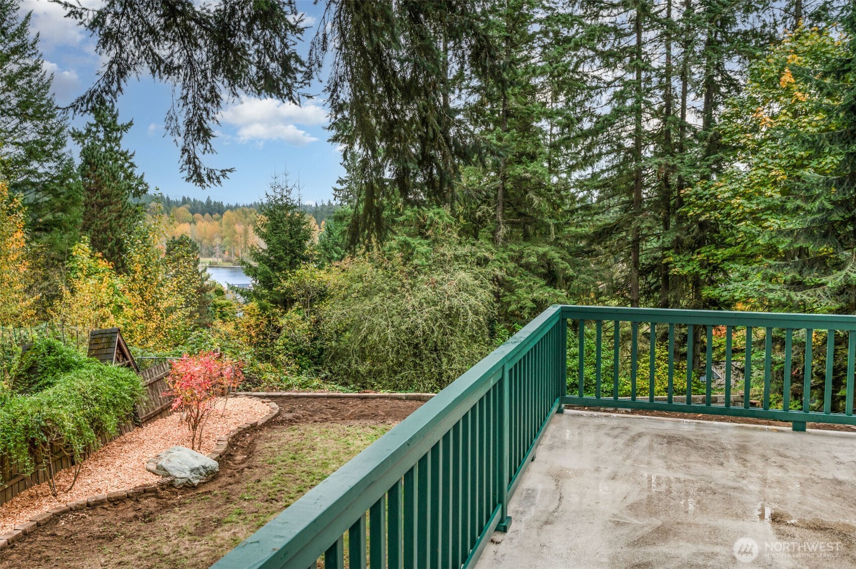 The full-length deck is perfect for entertaining or quiet mornings, offering seamless outdoor access through double French doors from the dining room and primary suite, all framed by stunning lake and mountain vistas.