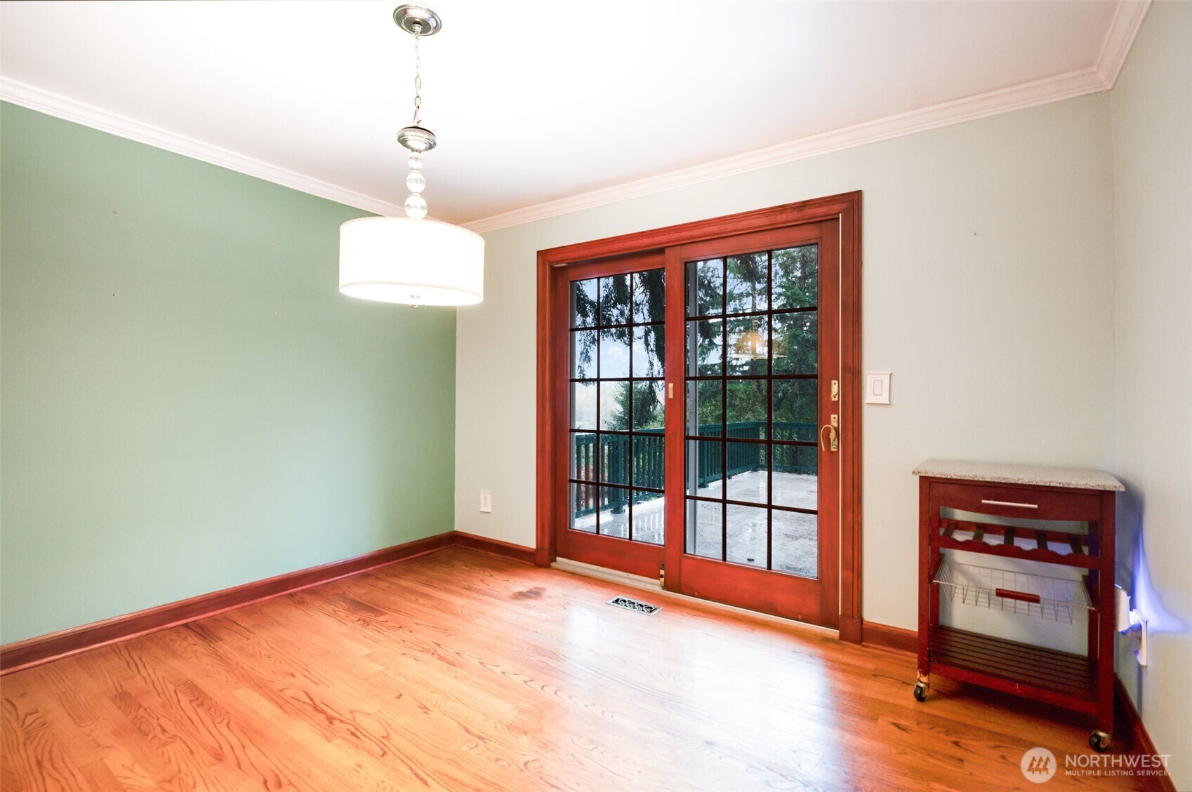 With its warm hardwood floors and seamless connection to the kitchen, the dining room opens through French doors to a scenic balcony where guests can dine or unwind while taking in the stunning lake and mountain views.