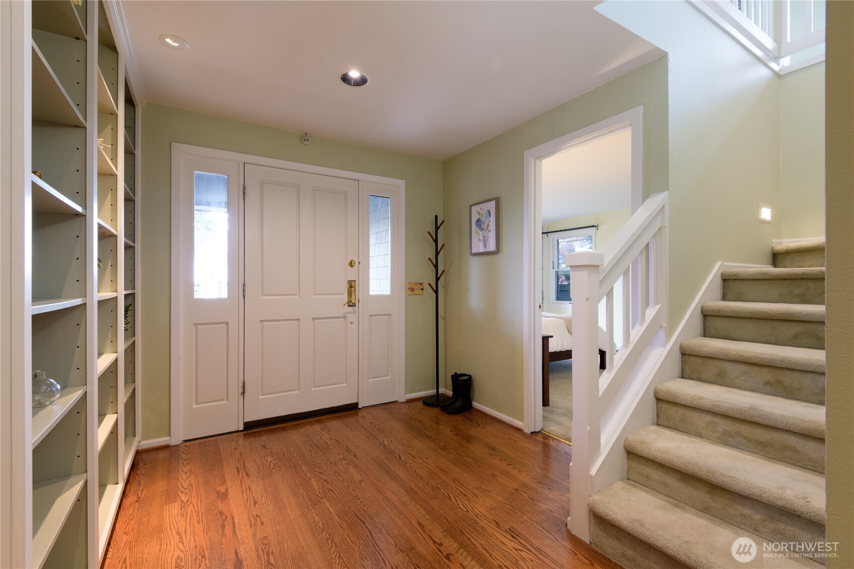 Front entry way, with book cases and hall closet