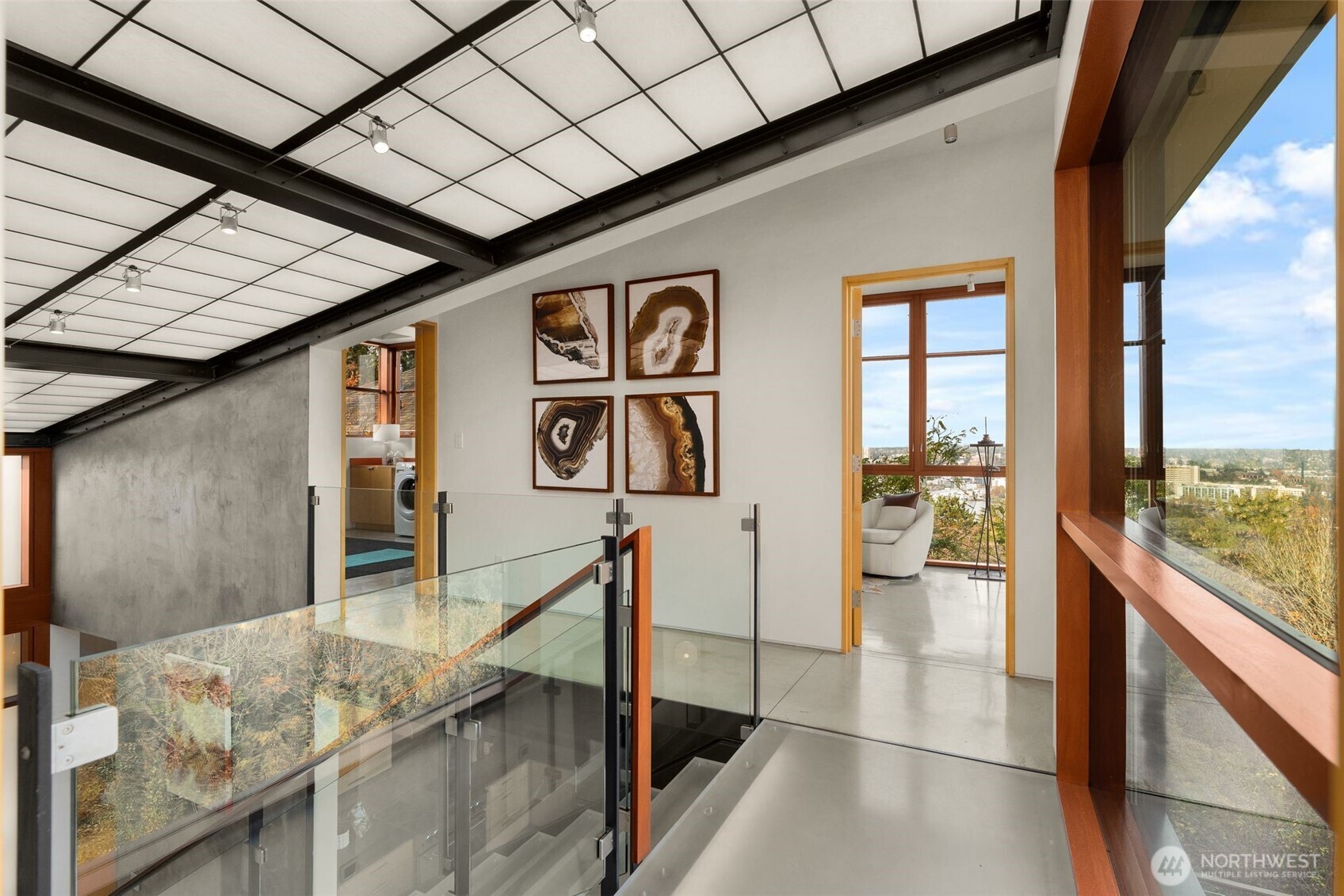 Daylight floods the home through a central translucent slot and floor-to-ceiling windows