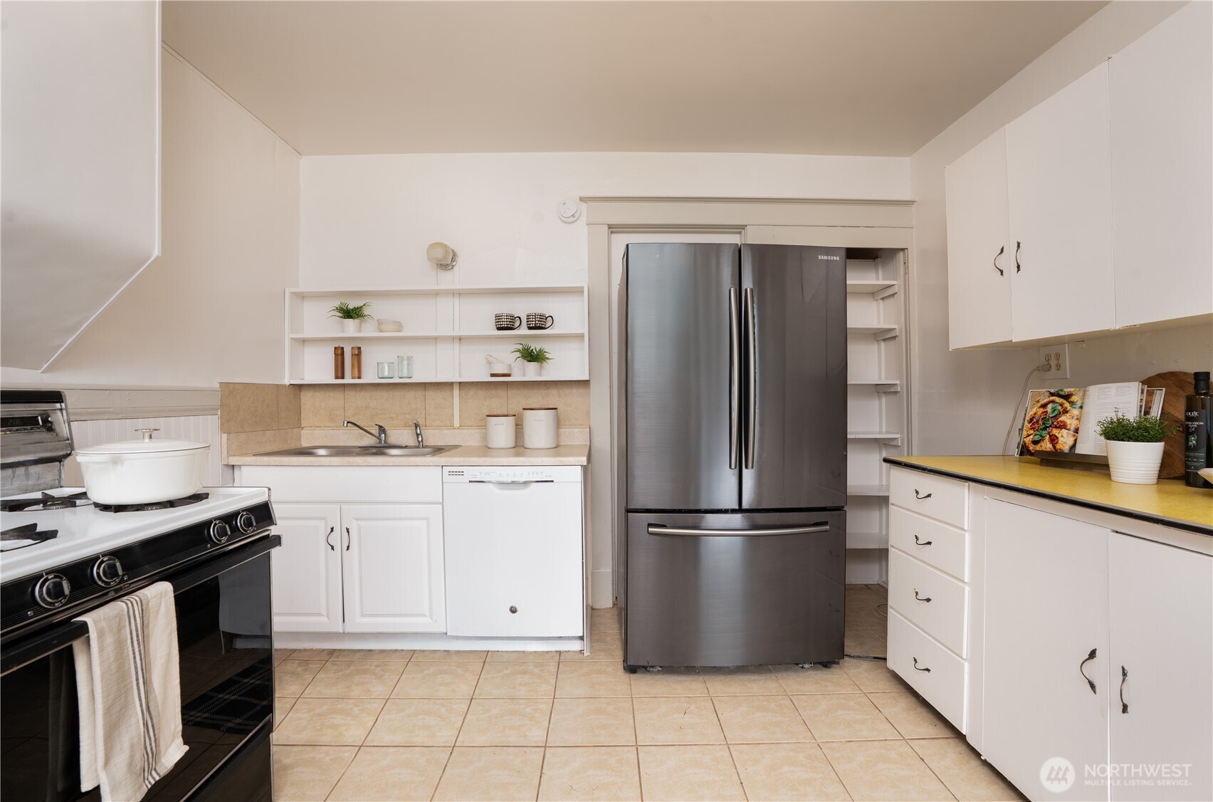 Beyond the kitchen, you’ll find the dining area and a second living space.