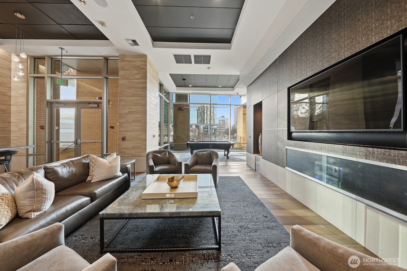 A newly renovated clubhouse perfect for entertaining, equipped with a chef's kitchen, pool table, and large dining table.