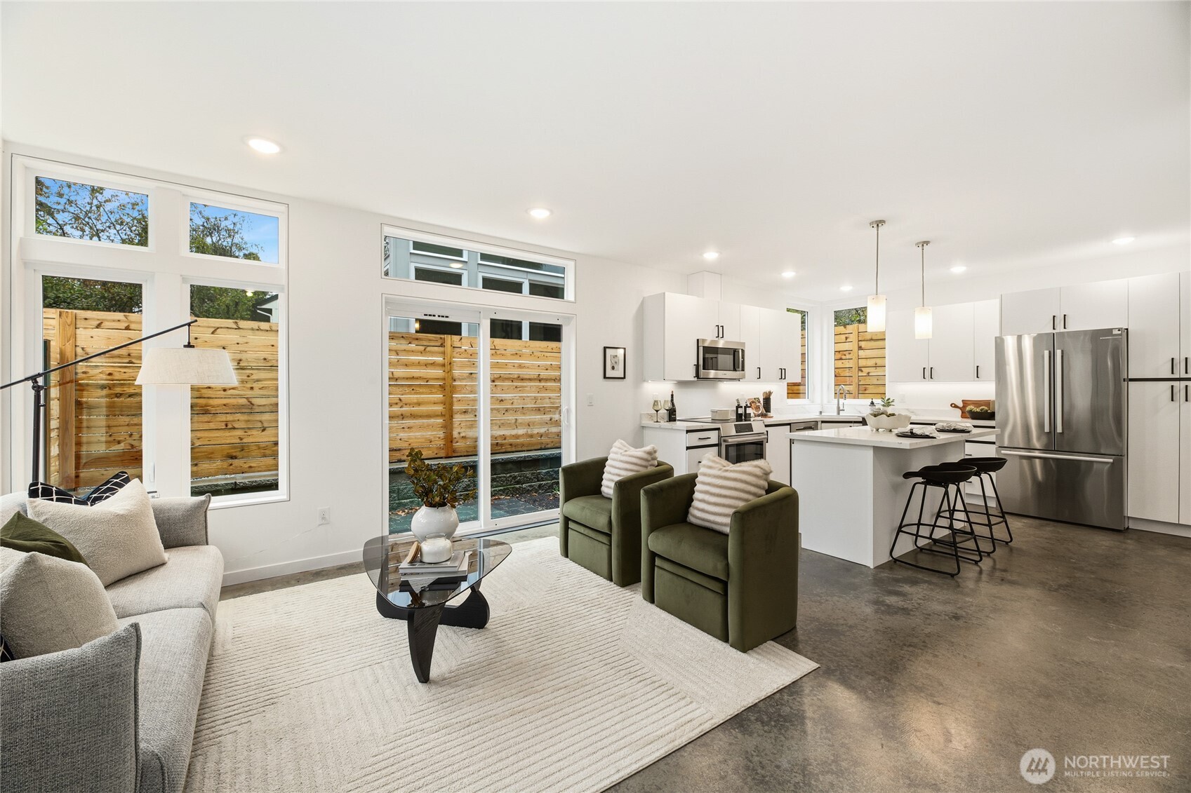 Open and bright living room that flows into the kitchen.