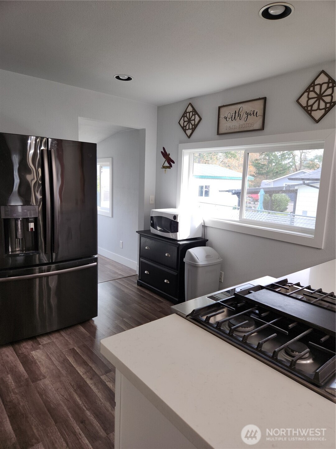 Entrance to upstairs room, the utility space and backyard off the kitchen.