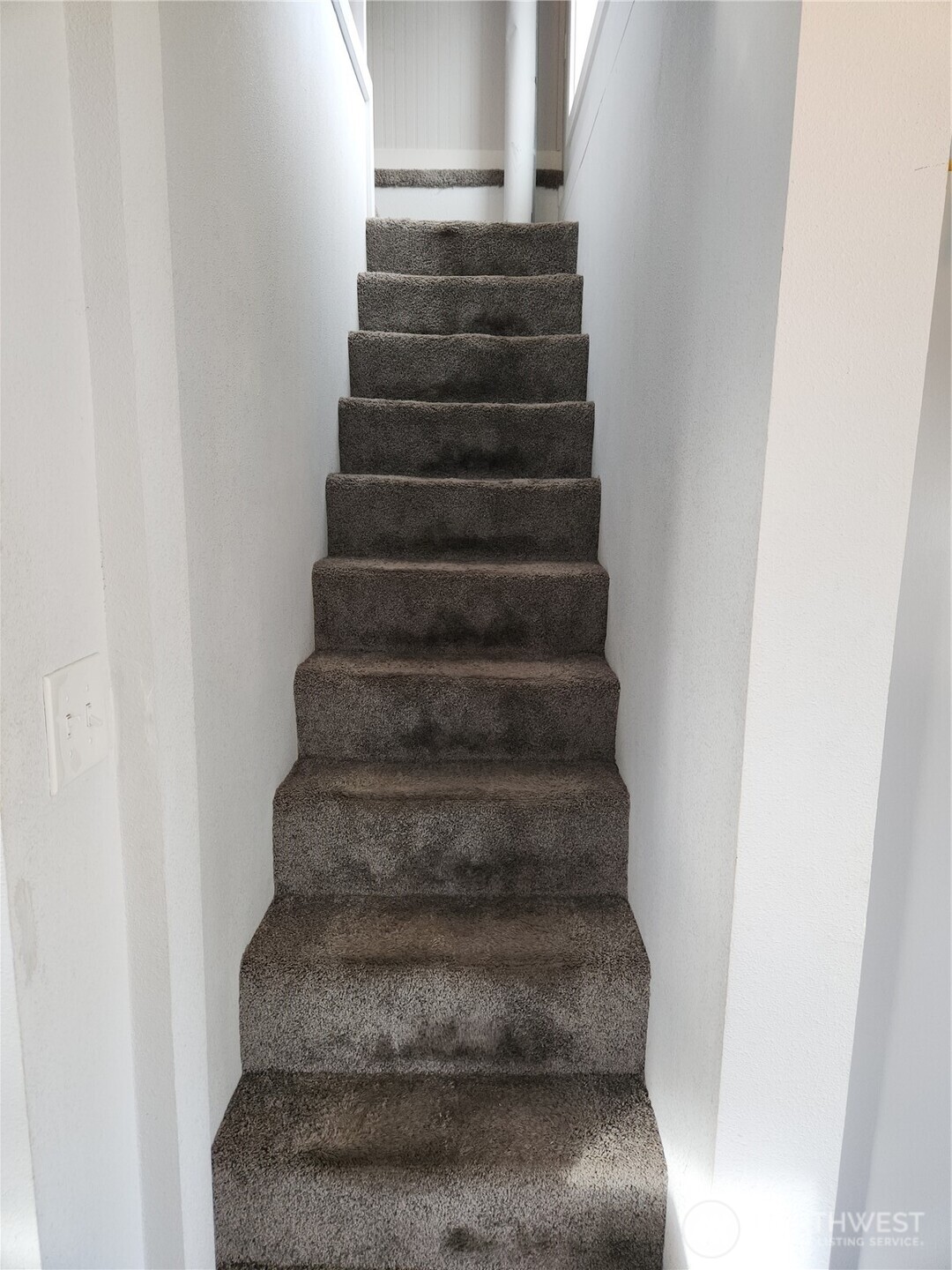 Upon entering the utility room, directly to the left are the stairs to the upstairs bonus/bedroom space.