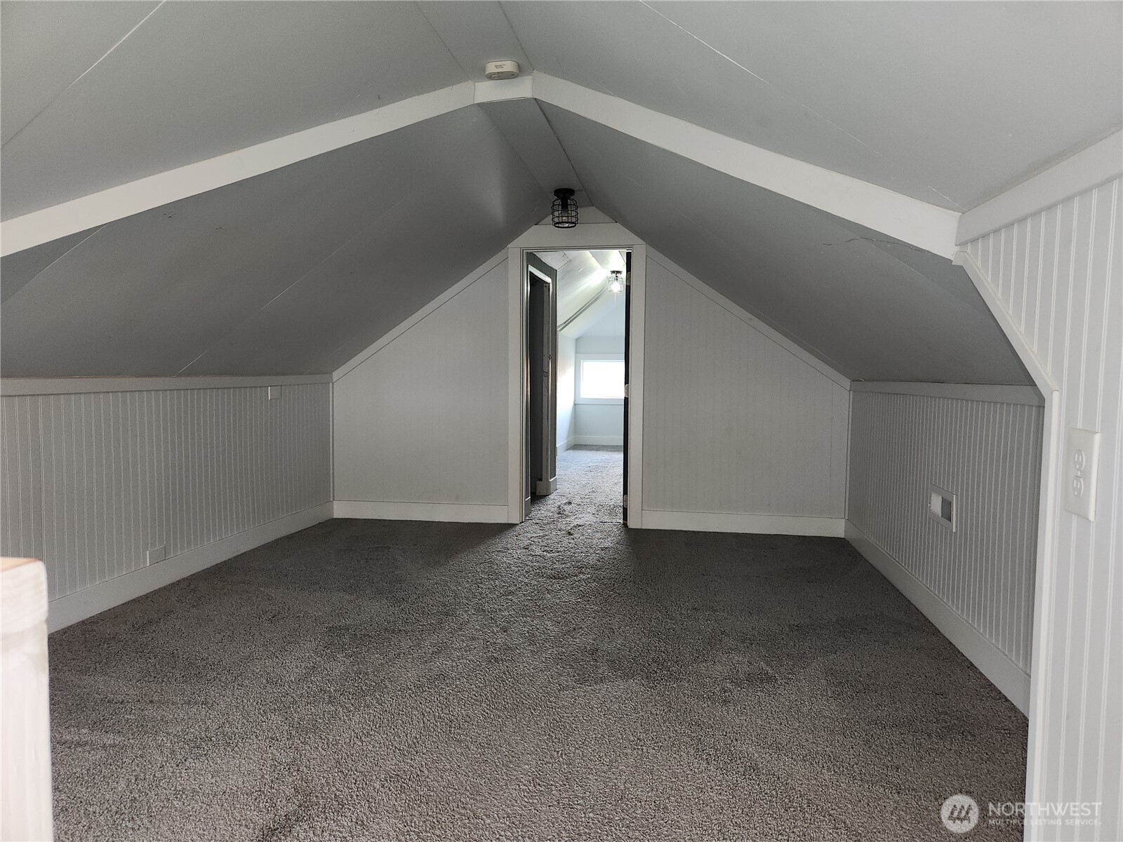 At the top of the stairs is this spacious bonus room you could make into a media or TV room.  Bedroom 3 is in view through the doorway.