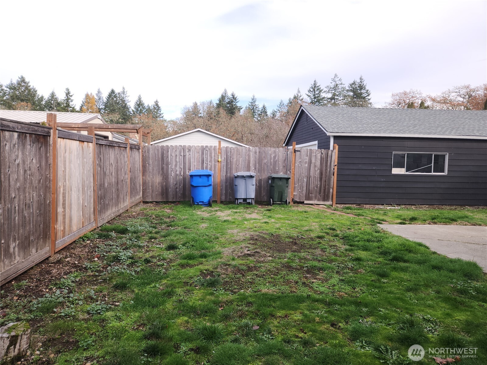 View of the fenced backyard from the shed.