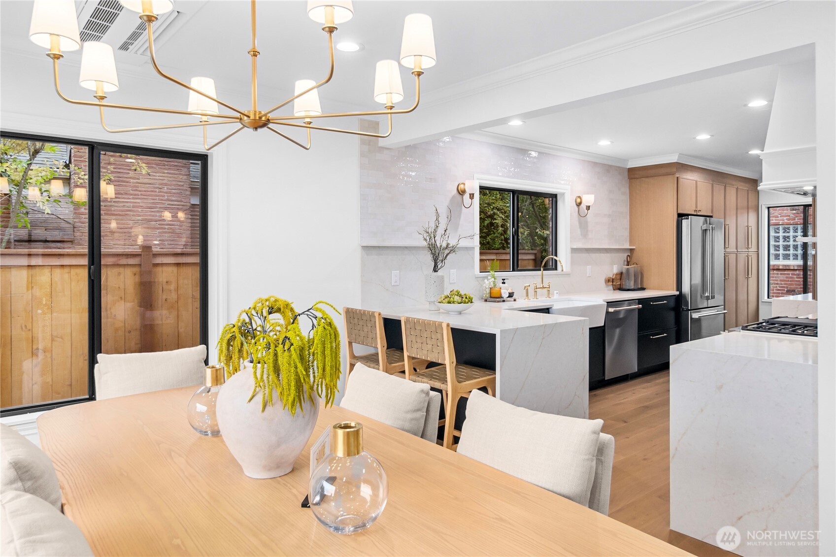 ...looking towards the gourmet kitchen featuring 3cm quartz counters, lavish full-height backsplash, Cafe stainless appliances, Shaker-style cabinetry... and wait for it...