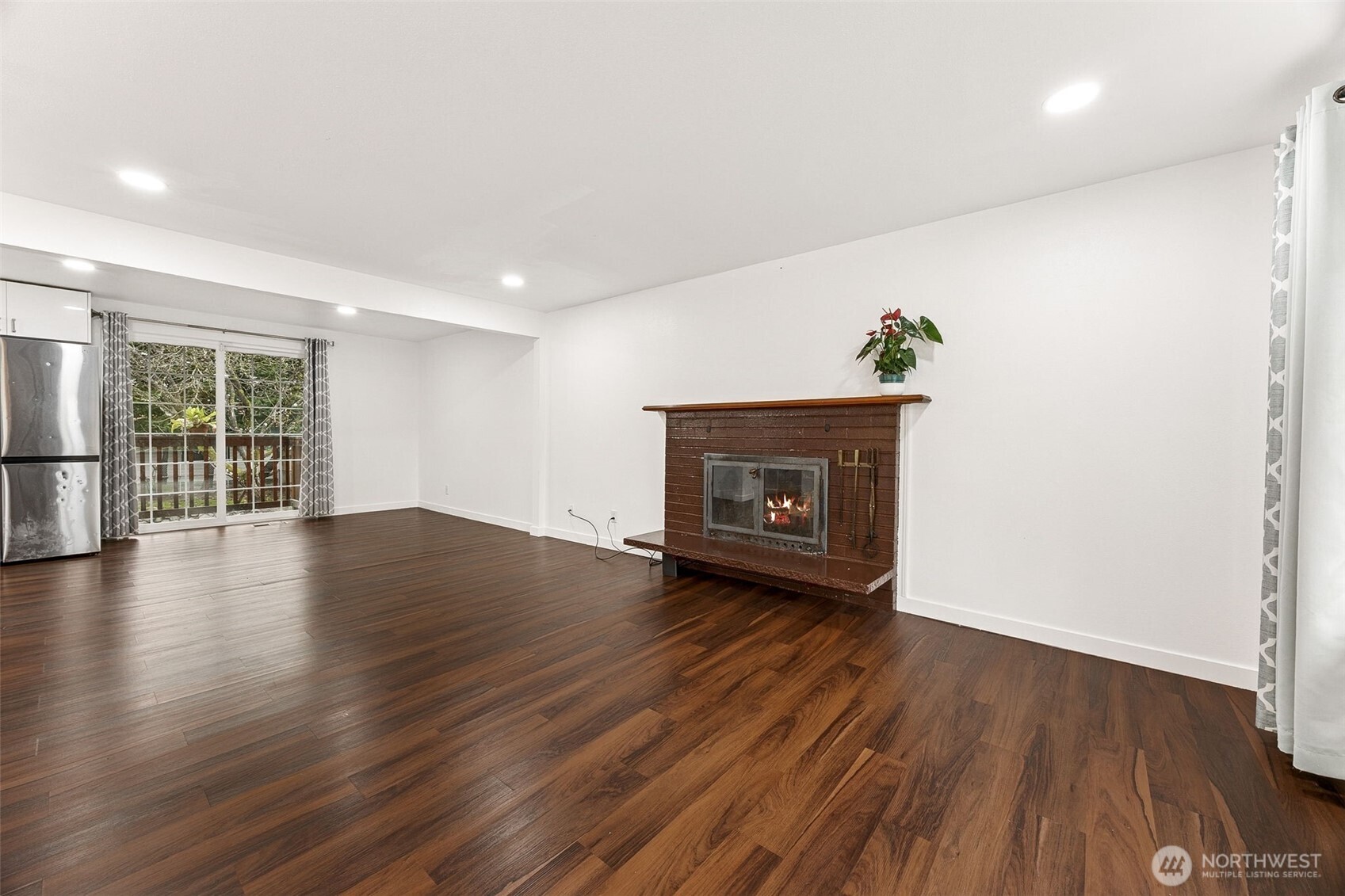 Main living room overlooking hallway holding three bedrooms and a full bathroom.