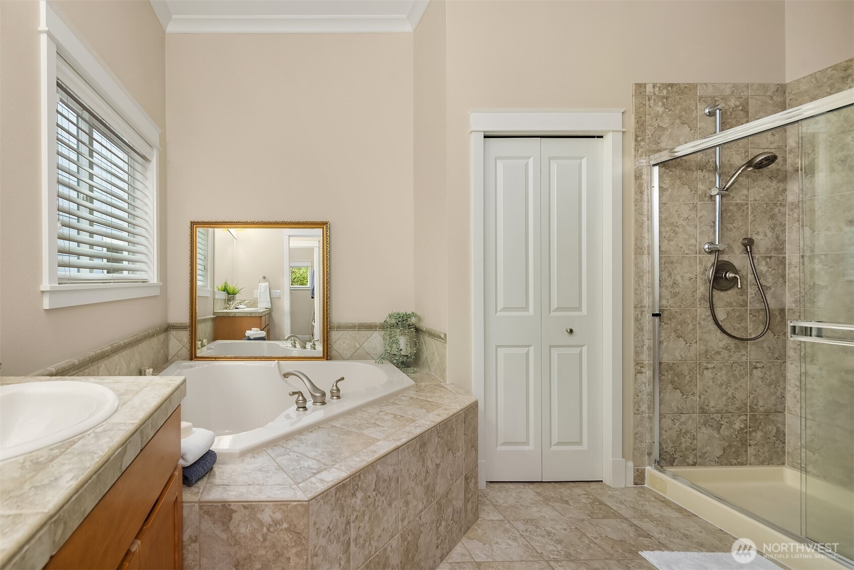 Spacious Primary Suite with loads of windows and door to back English Slate patio