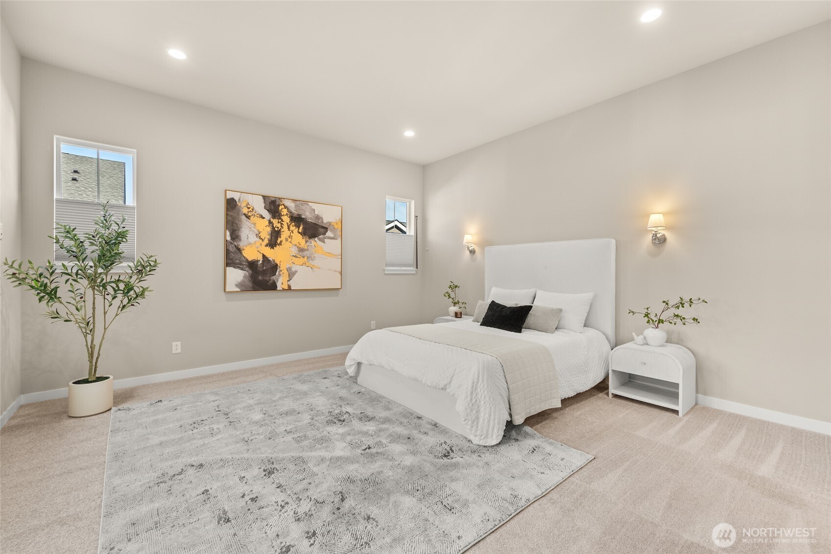 Wake up to soft light and peaceful surroundings in the primary bedroom.