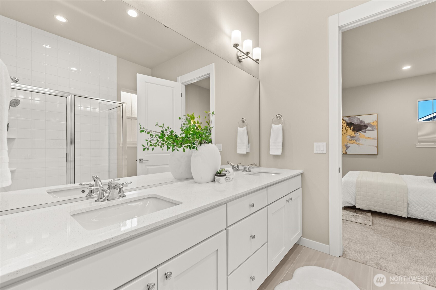 Roomy spa-like bathroom with dual sinks and modern finishes.