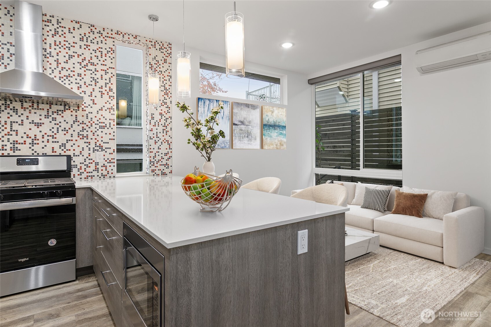 The kitchen is a standout featuring quartz countertops, gas cooking, a walk-in pantry and an oversized kitchen island.