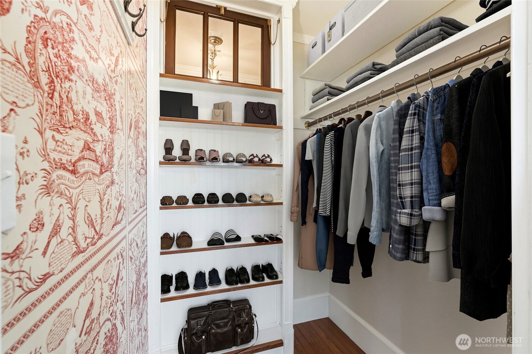 Spacious walk-in closet featuring charming, vintage-inspired touches.