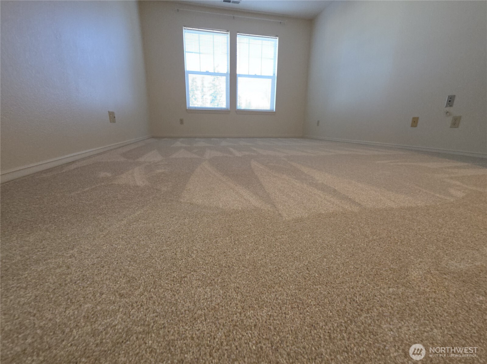 Primary bedroom.  Closets on the right; exit to the left.  Bathroom behind photographer.