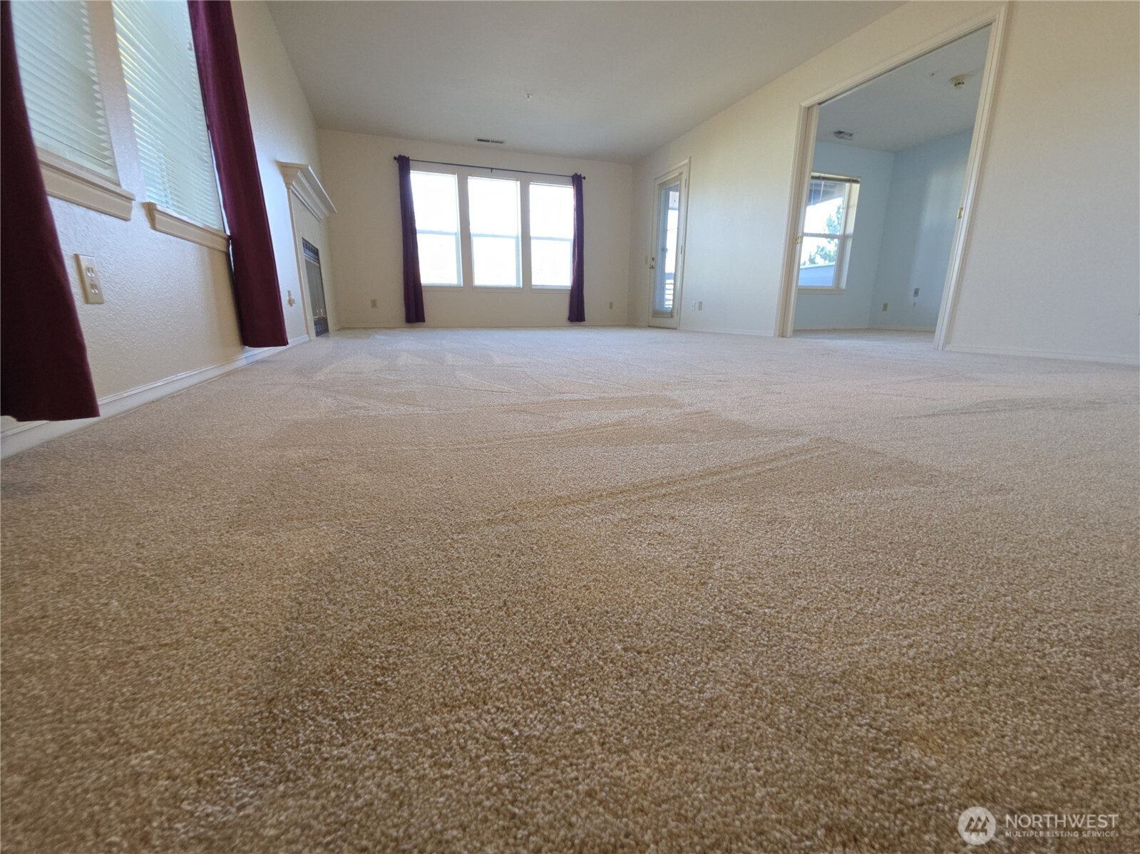 Hallway on right leads to the Primary bedroom.  Turn R before that door to exit the unit