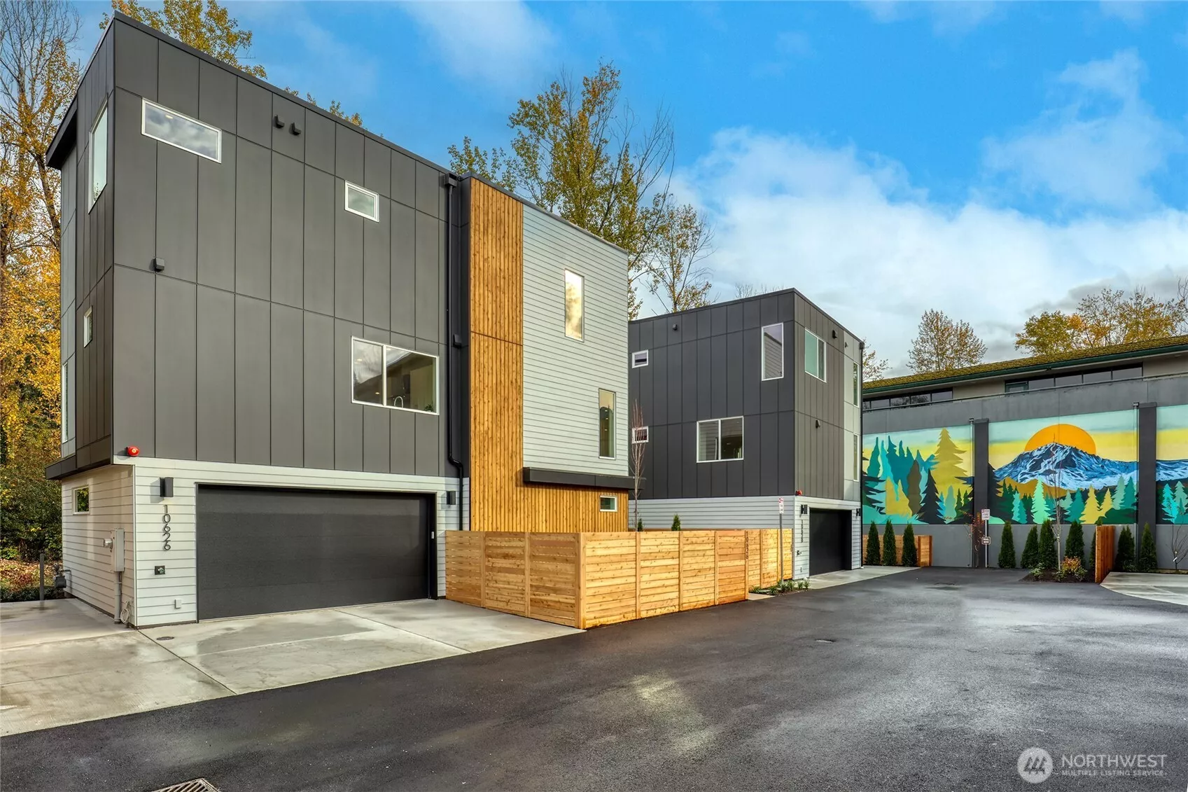 Two-bay EV ready garage, and fenced front yard.