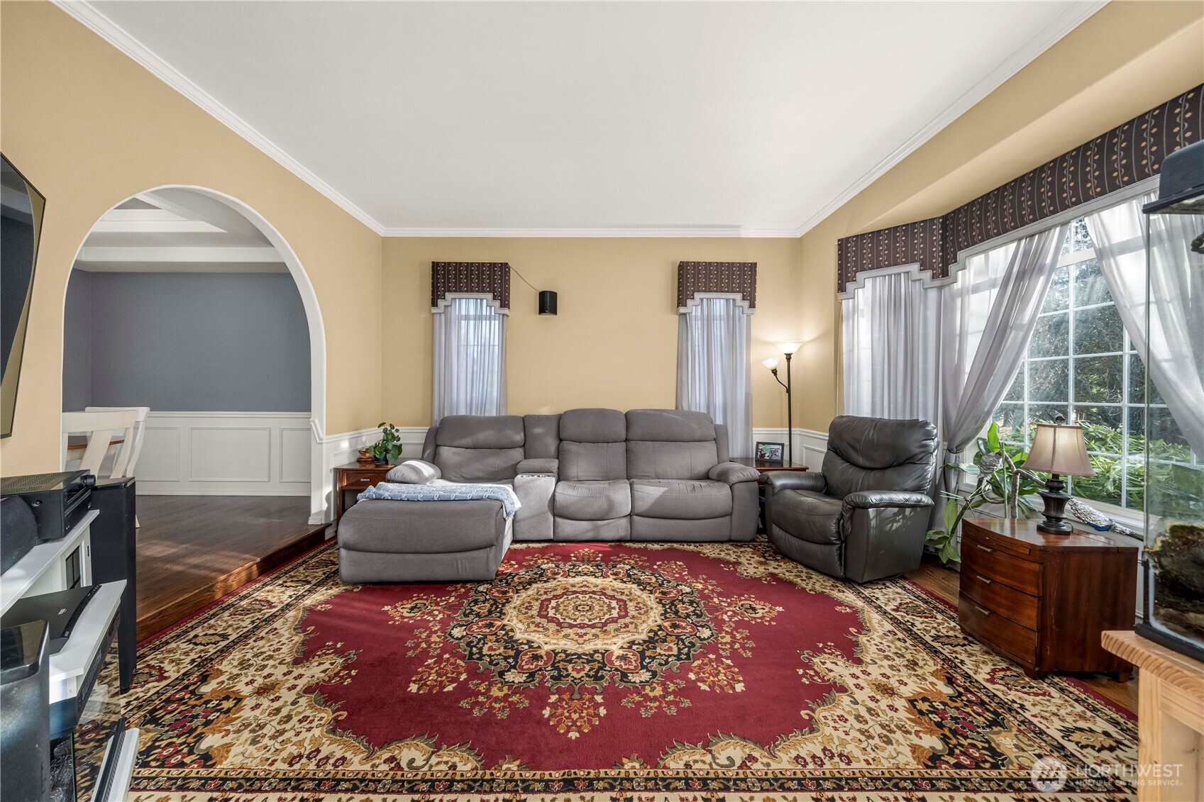 Formal living room at the front of the home with 5 windows letting in all the natural light