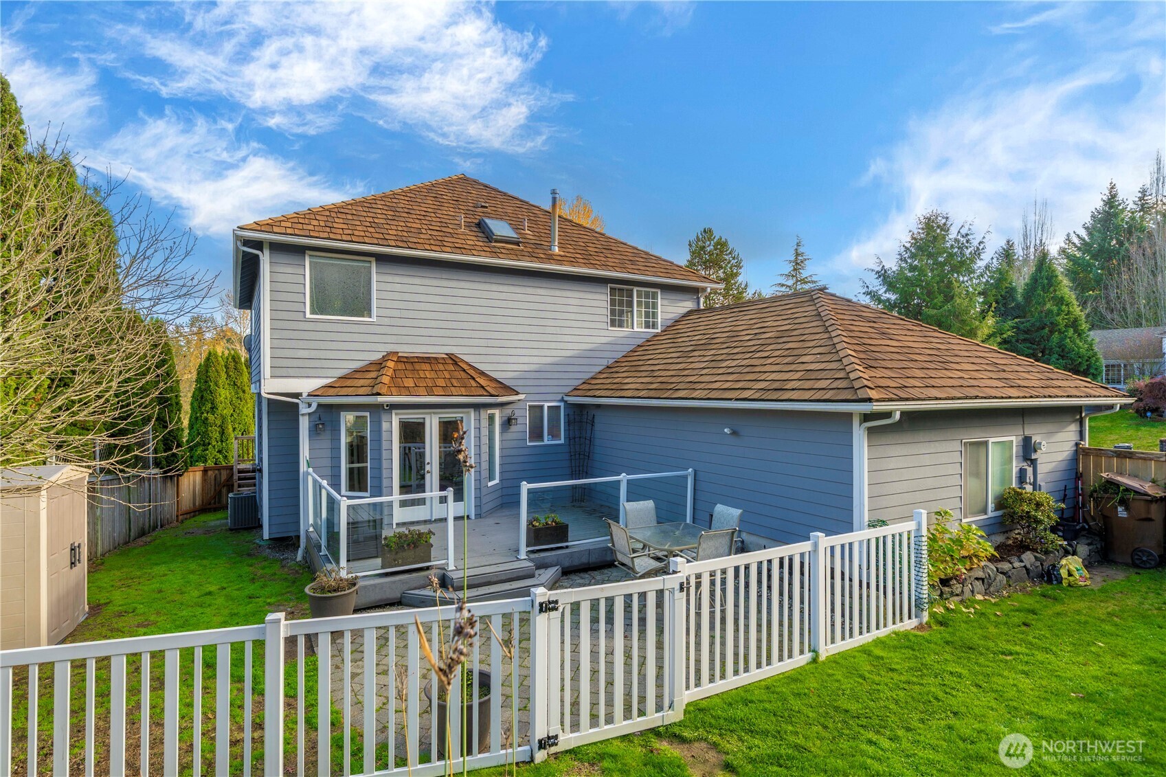 Trex deck steps down to a gated paver patio, thoughtfully separated from the koi pond and garden oasis.