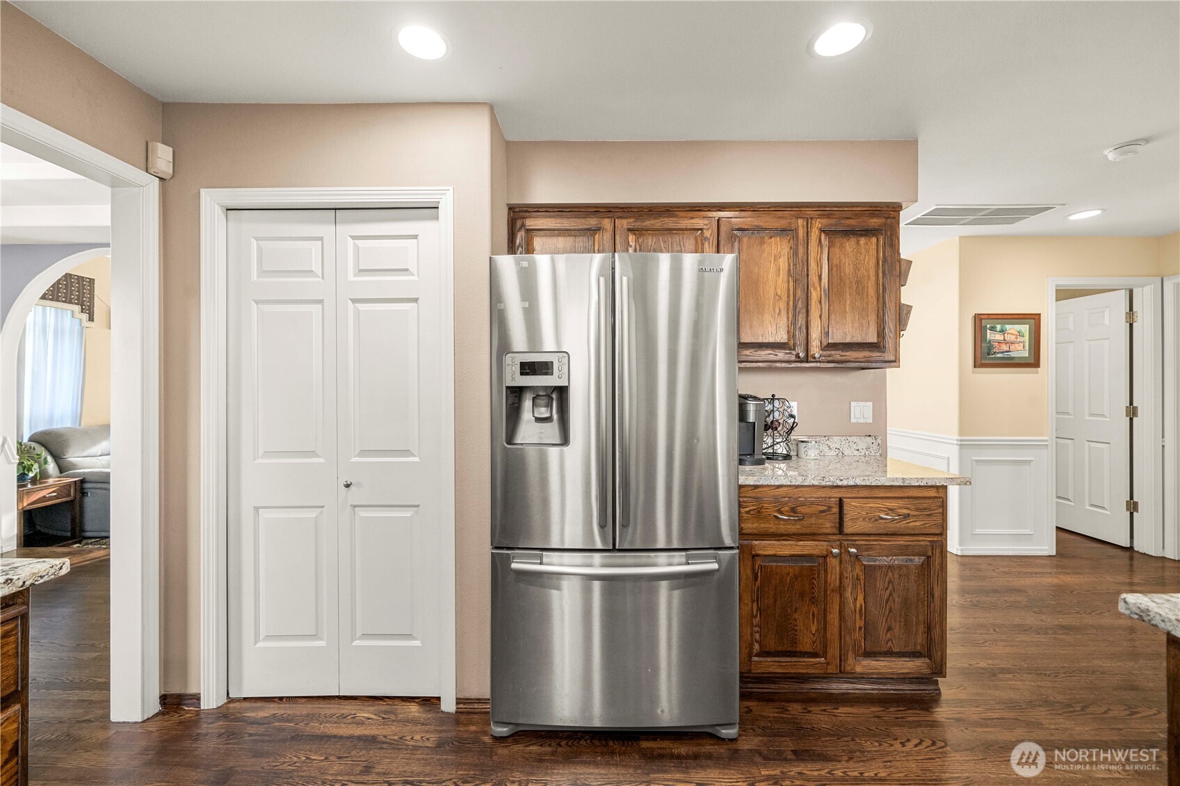 All stainless steel appliances and perfectly positioned pantry, fridge and coffee (or liquor) bar