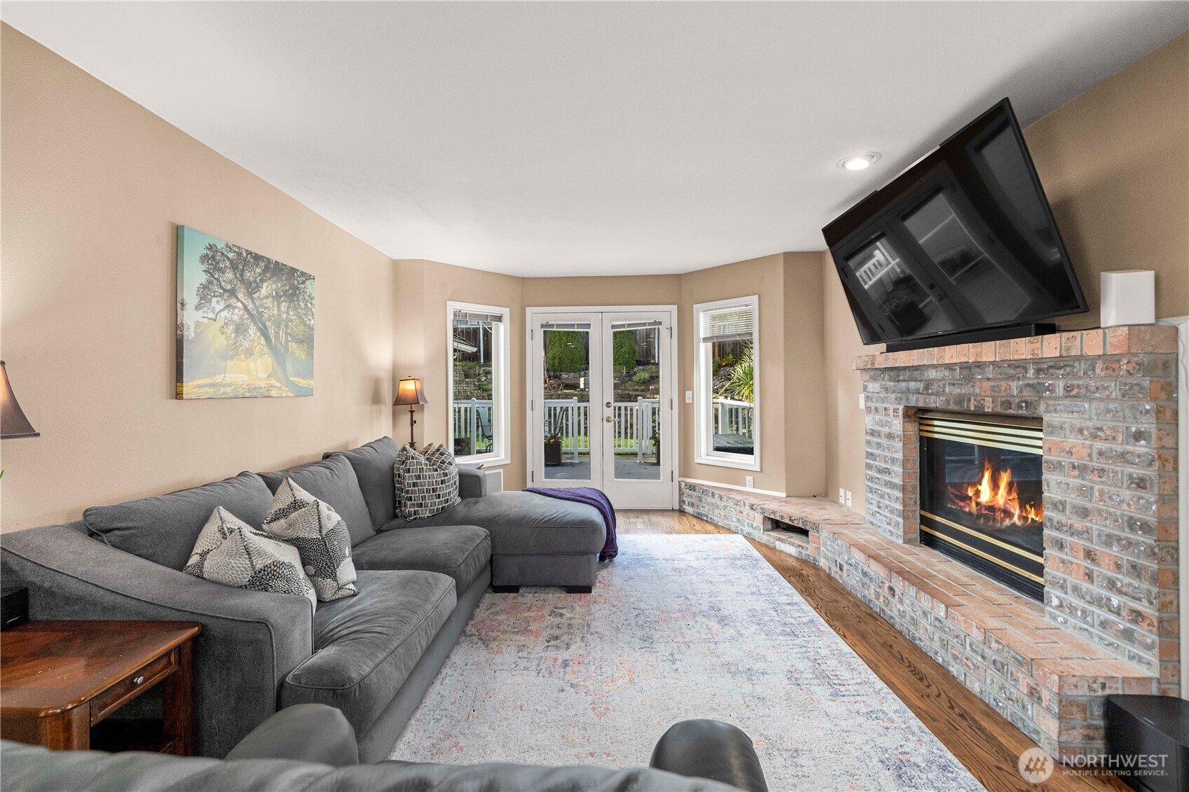 French doors continue the living space outdoors to beautiful Trex decking and concrete paver patio