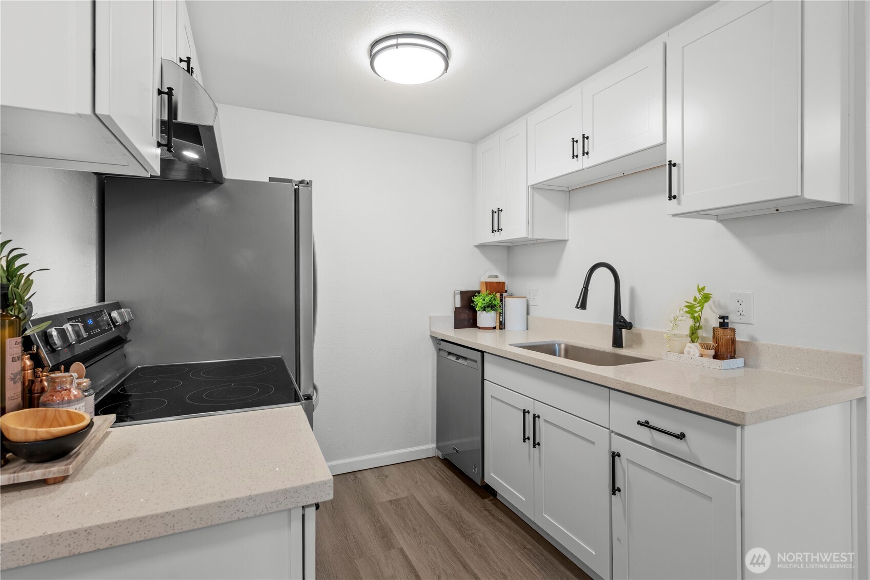 1 of 2 light filled bedrooms with modern luxury plank vinyl.