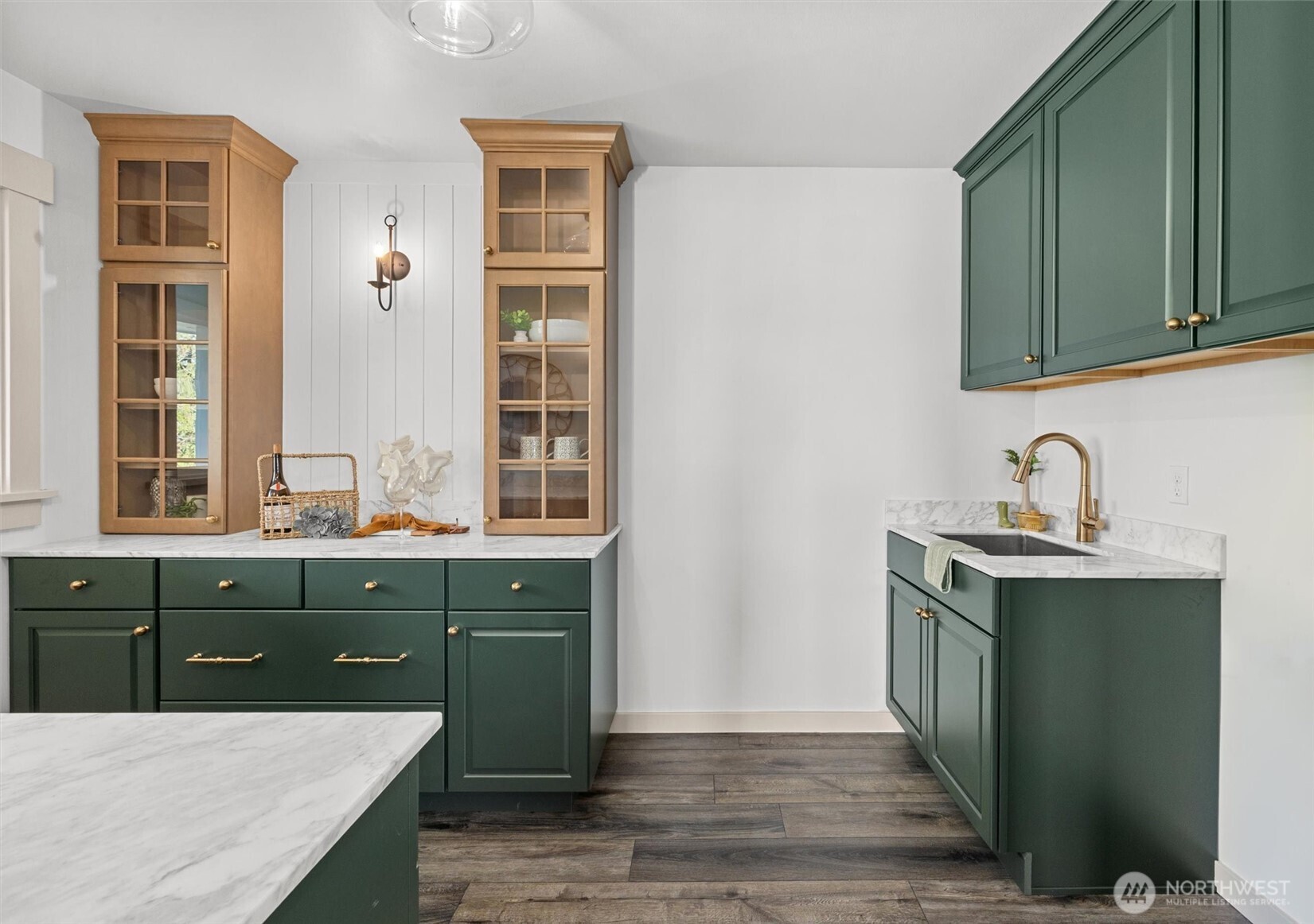 Butler's pantry off hearth room with custom cabinetry, marble countertops and Thermador stainless steel beverage refrigerator. Perfect for entertaining! Also serves as main floor laundry room with utility sink too!