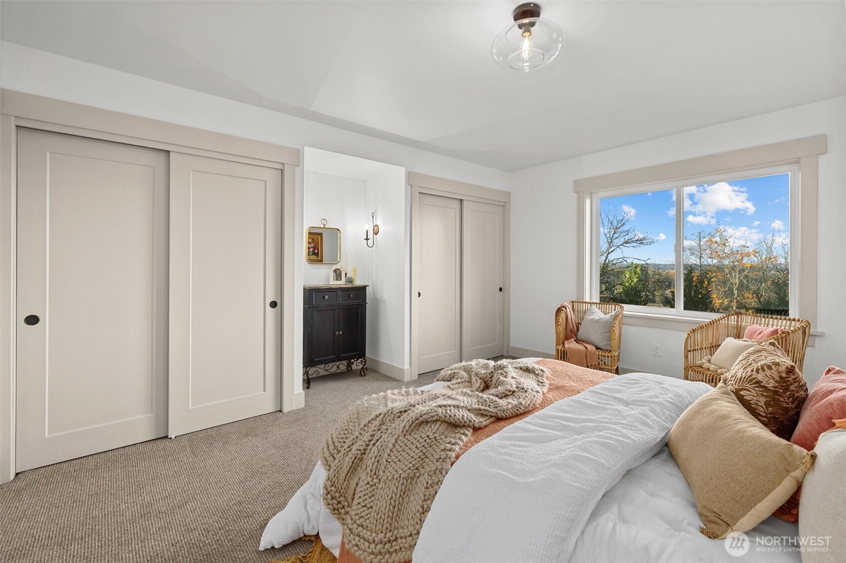 Lower-level guest bedroom (1 of 2 identical rooms) with wall sconces, double closets and spectacular views!