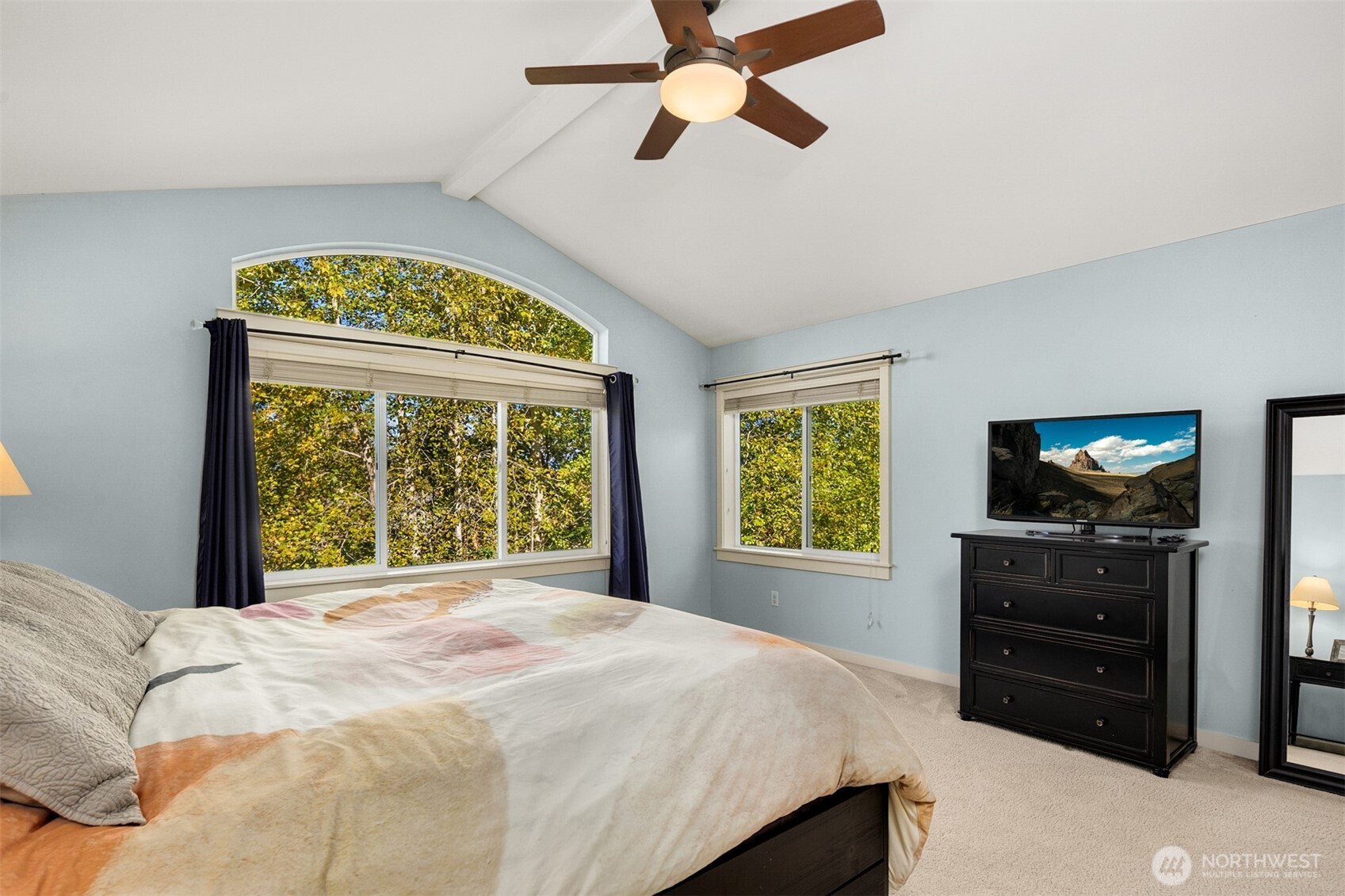 Primary bedroom with vaulted ceiling