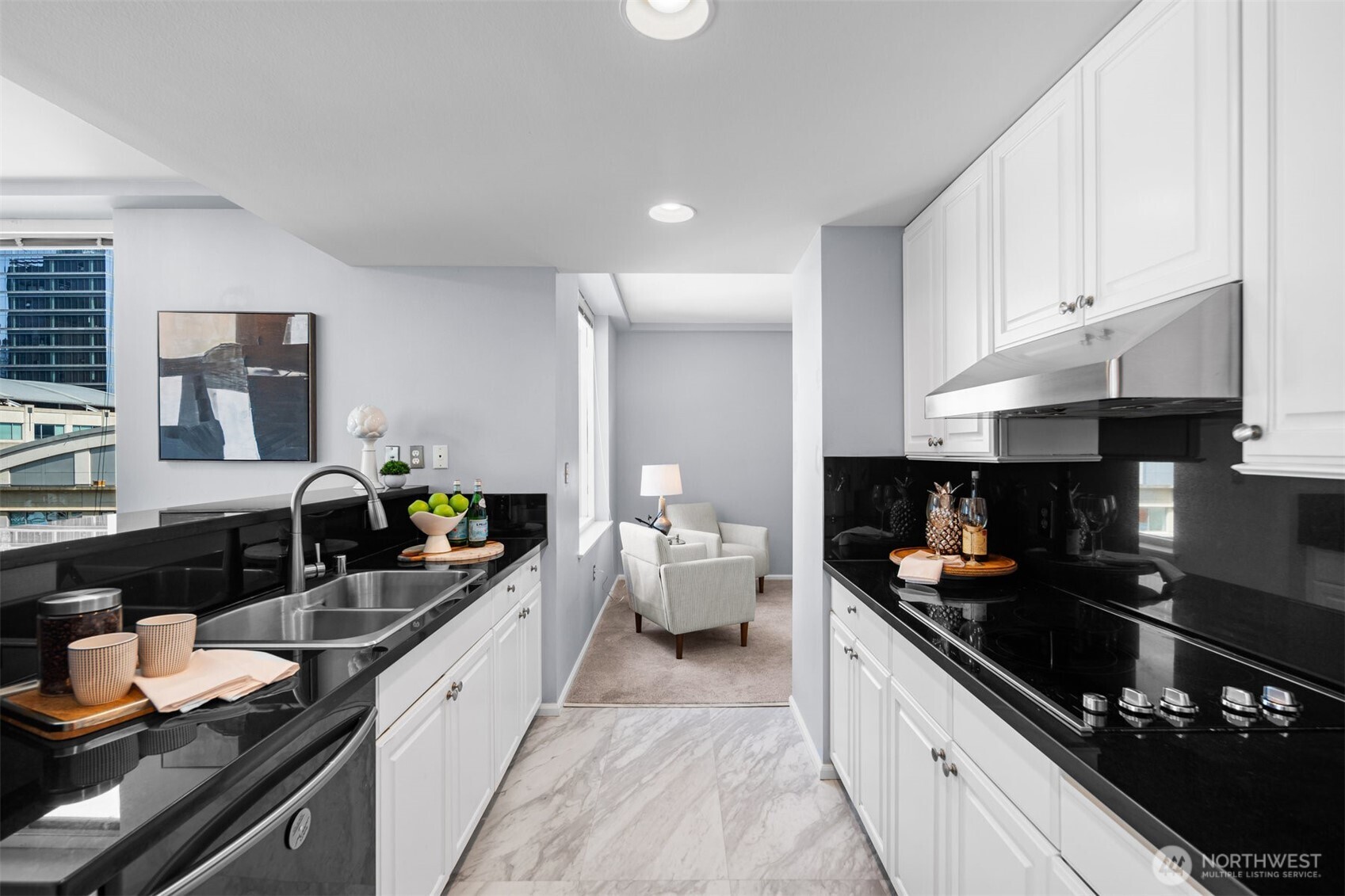Gourmet kitchen featuring sleek black granite and updated appliances. Perfect for urban living in downtown Bellevue.