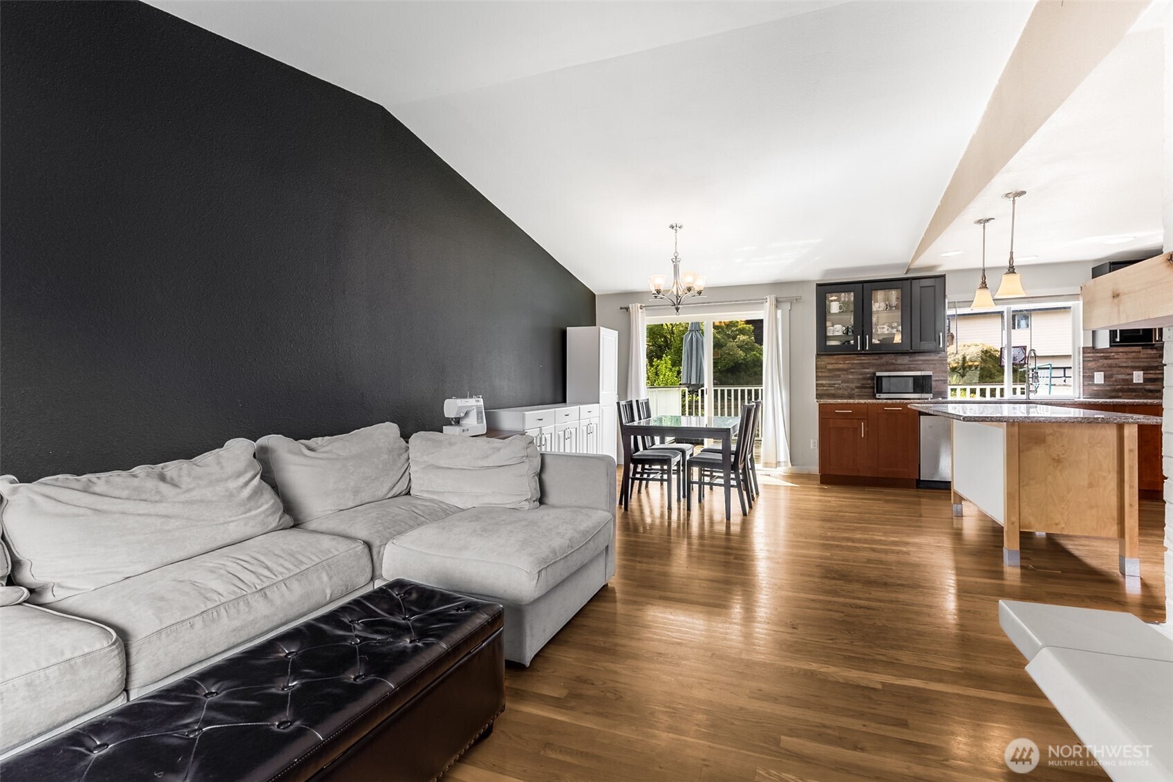 Cozy Living Room with Wood-burning Fireplace is Open to the Dining Room