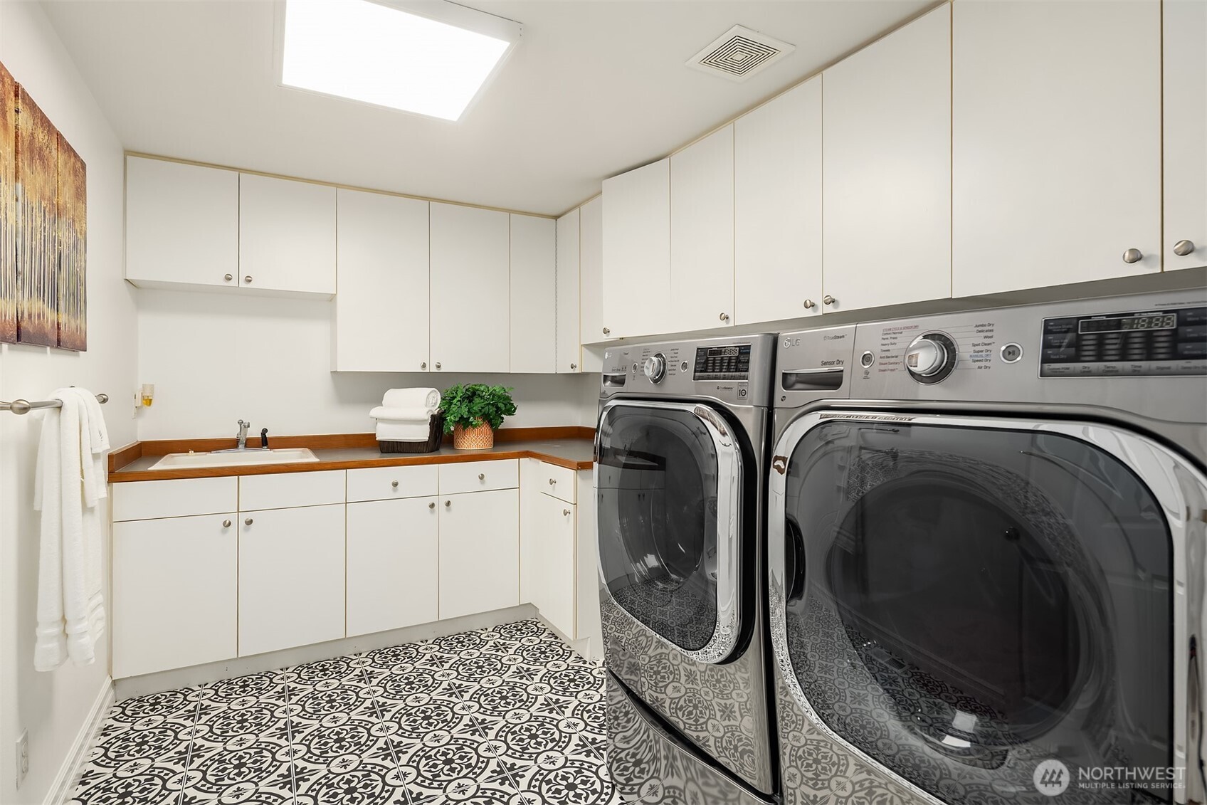 Utility room on main features a sink and tons of storage.