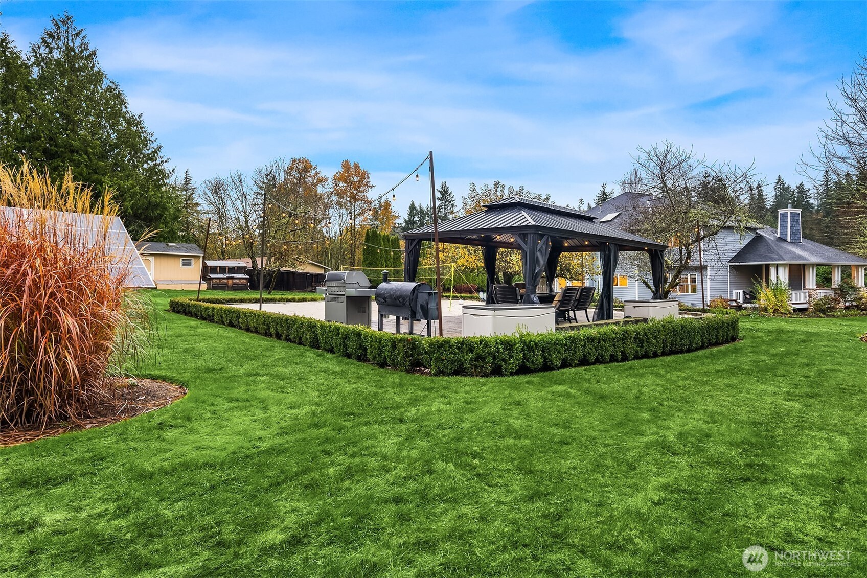 A play structure once stood here. Today this is affectionately know as "The Beach." Screened in pergola with power, lights, and outdoor fans stays. Beside it, a volleyball/badminton court filled with sand. Or you could do as the current owners did and set up lawn chairs!