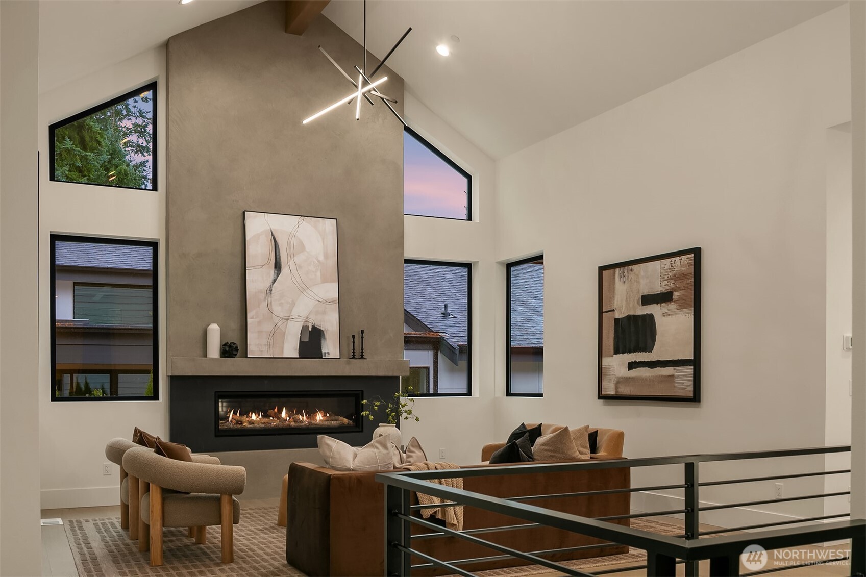This great room impresses with 17-ft ceilings, a sleek 62” Napoleon Vector fireplace, a fir-wrapped glulam beam, and built-in surround-sound speakers