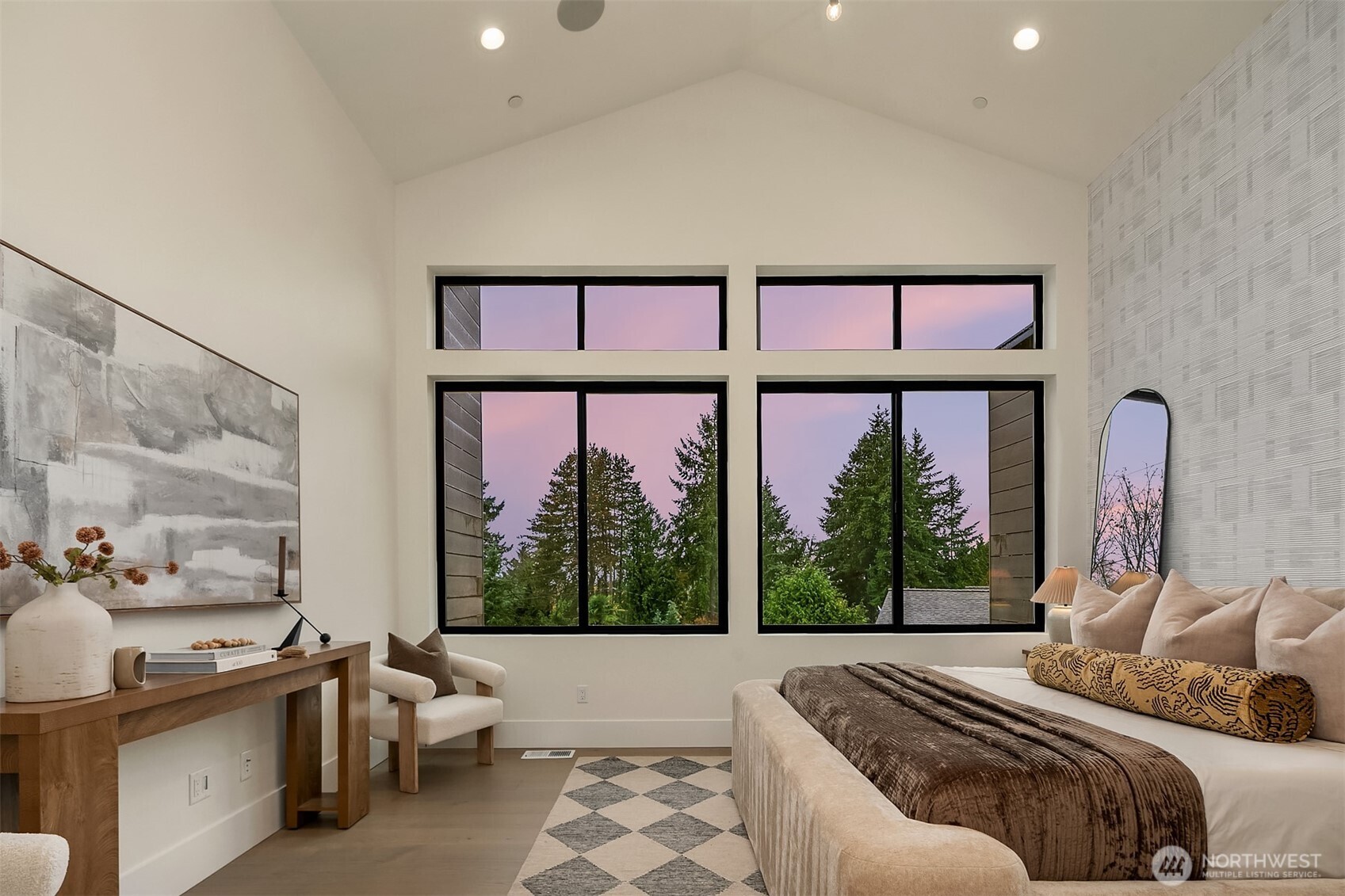 Exquisite primary suite featuring soaring ceilings and a spacious walk-in closet with custom organizers. The luxurious five-piece spa bath boasts heated floors and instant hot water in every faucet
