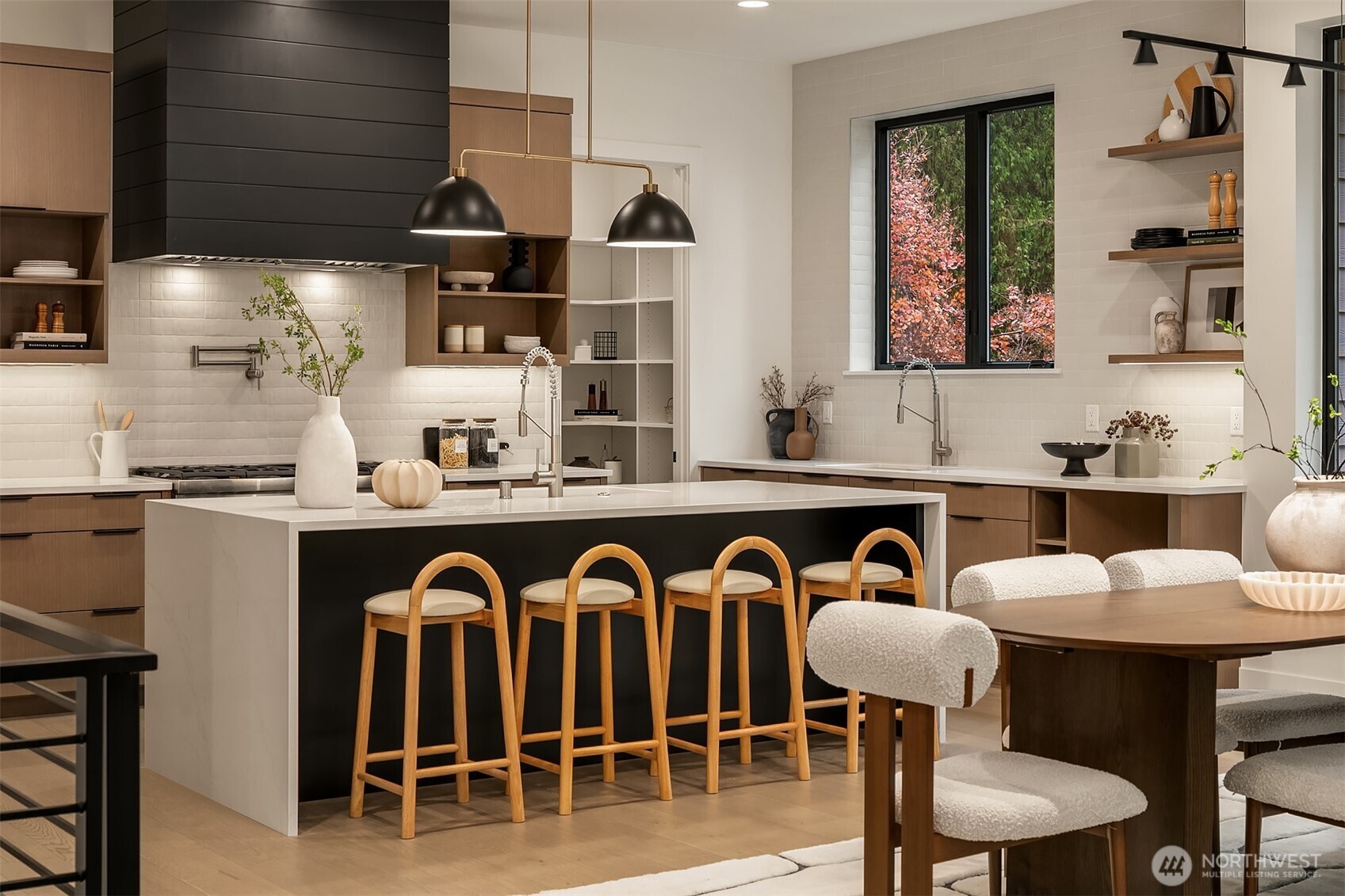 Step into a culinary dream with Thermador appliances, a 48-inch six-burner range, oak cabinets, walk-in pantry, and a quartz double-waterfall island that anchors the space.