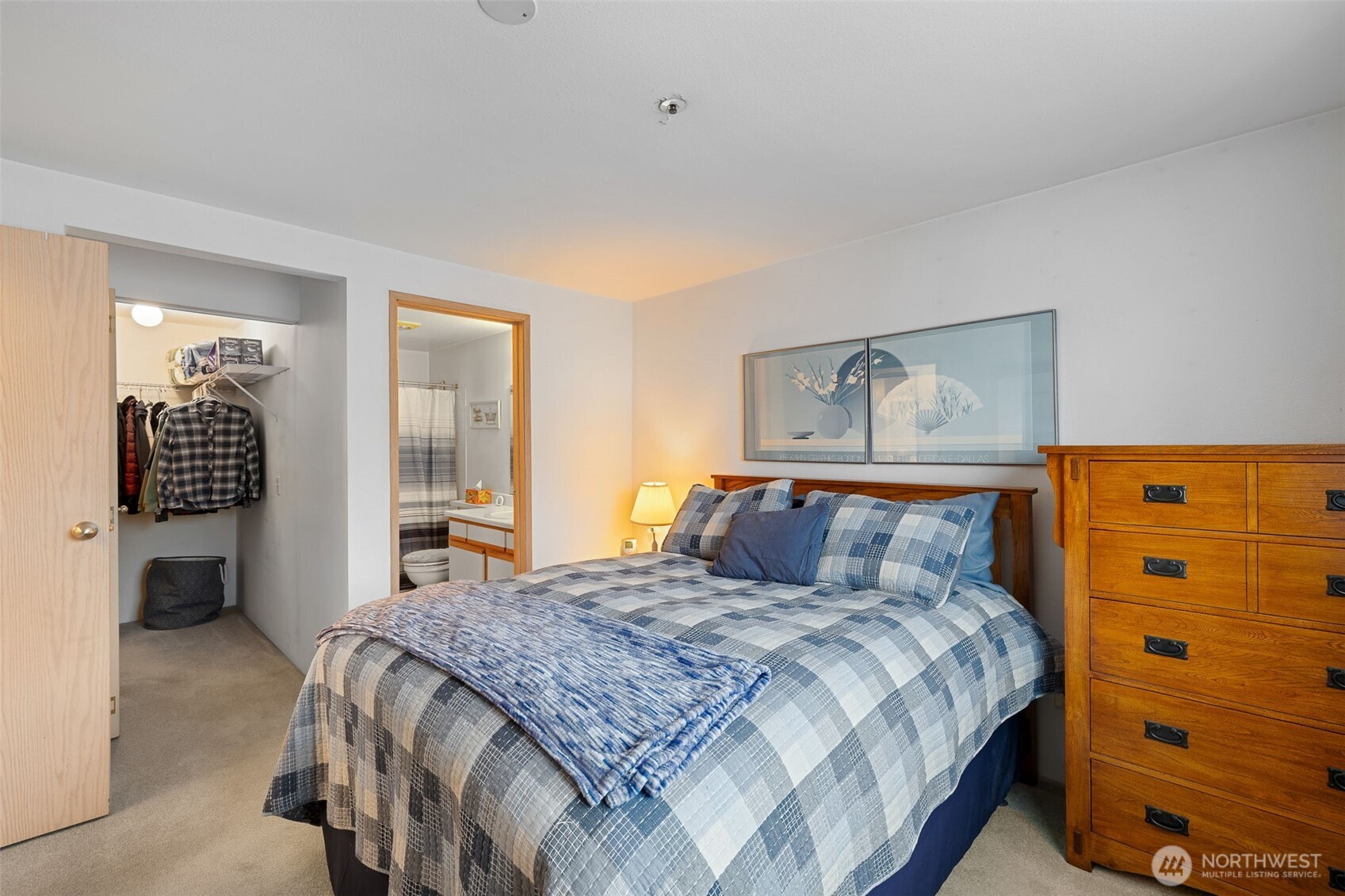 Primary bedroom with walk in closet and primary bathroom