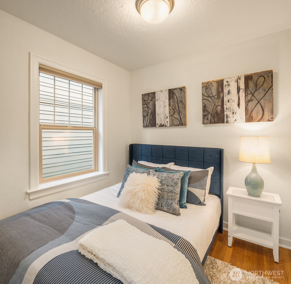 Efficient bedroom accommodates a queen bed.