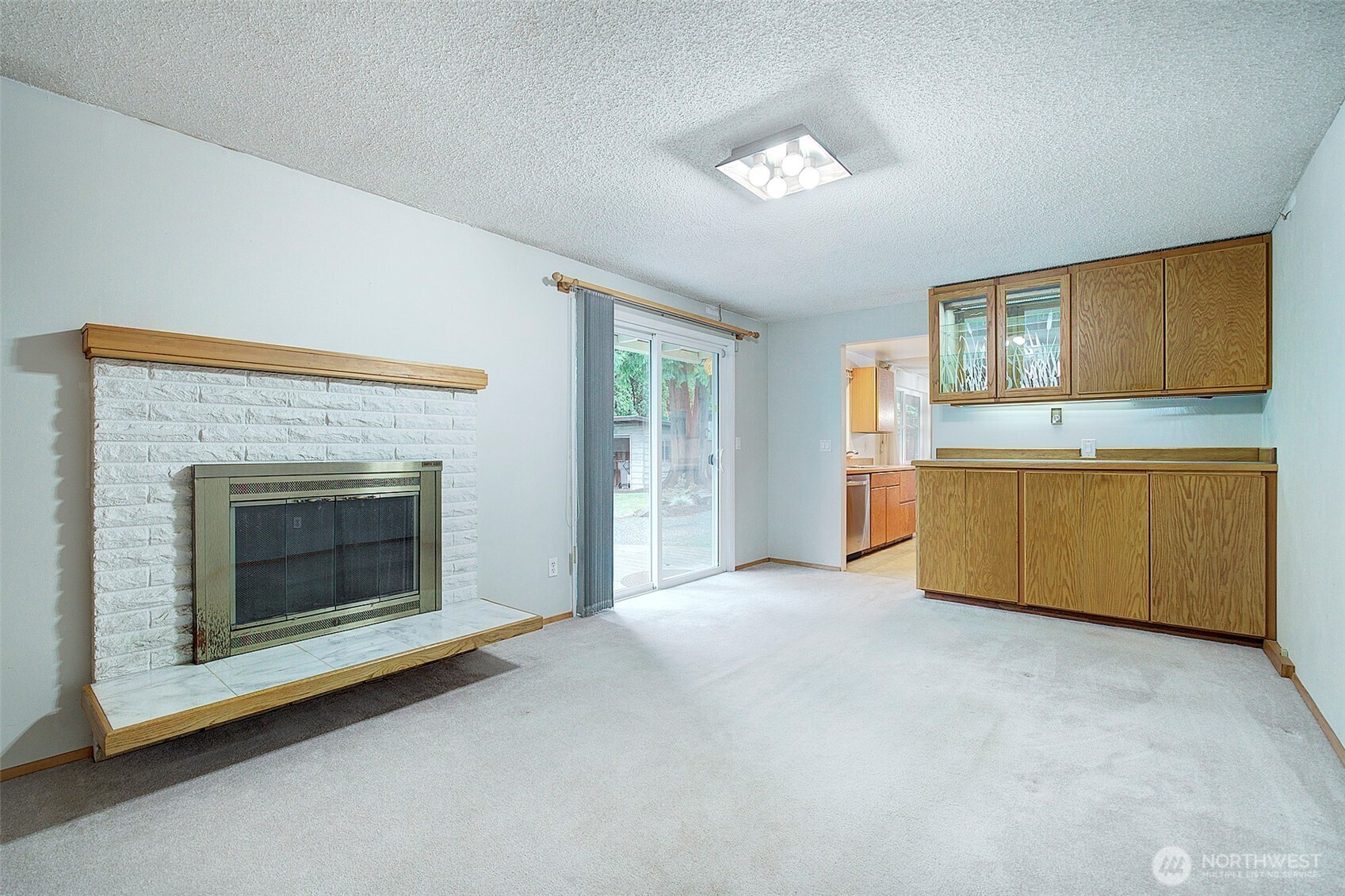 In addition to the living room, there's a bonus room that opens to the deck in the back yard. A wood burning fireplace will keep you cozy in the winter.