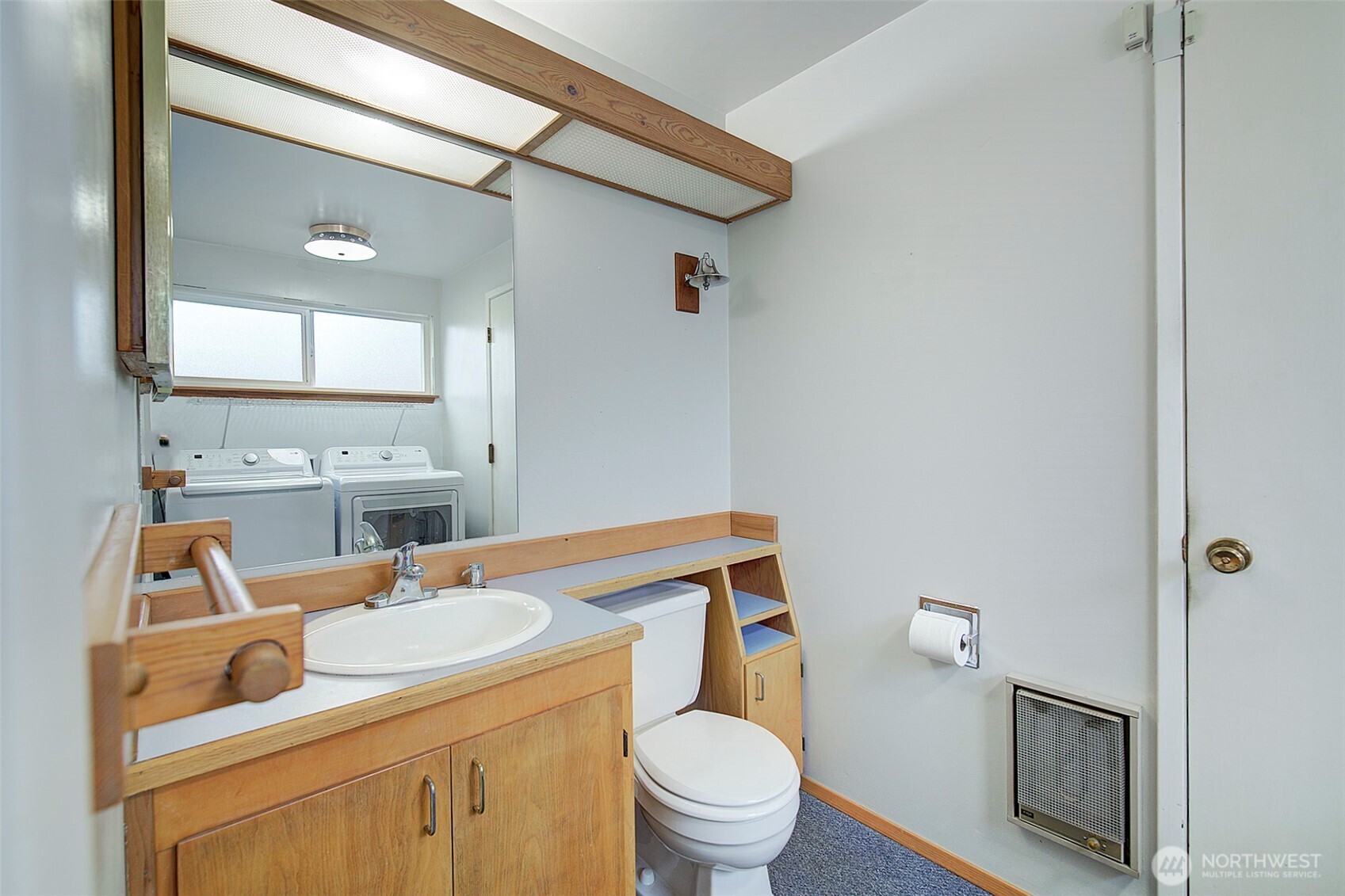 This half bathroom is adjacent to workbench space in the garage. Potential to expand and add a shower/tub?