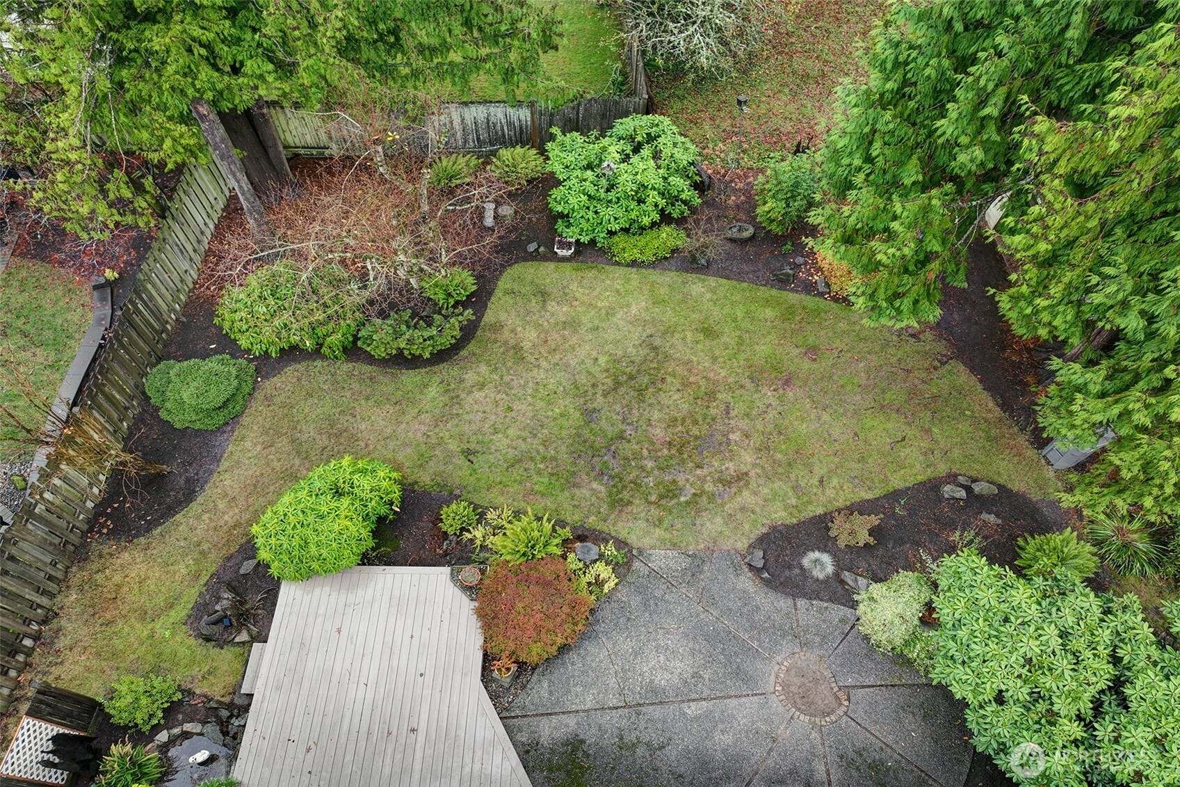 The backyard is ready for outdoor enjoyment with its composite deck, small pond with a fountain and patio space.