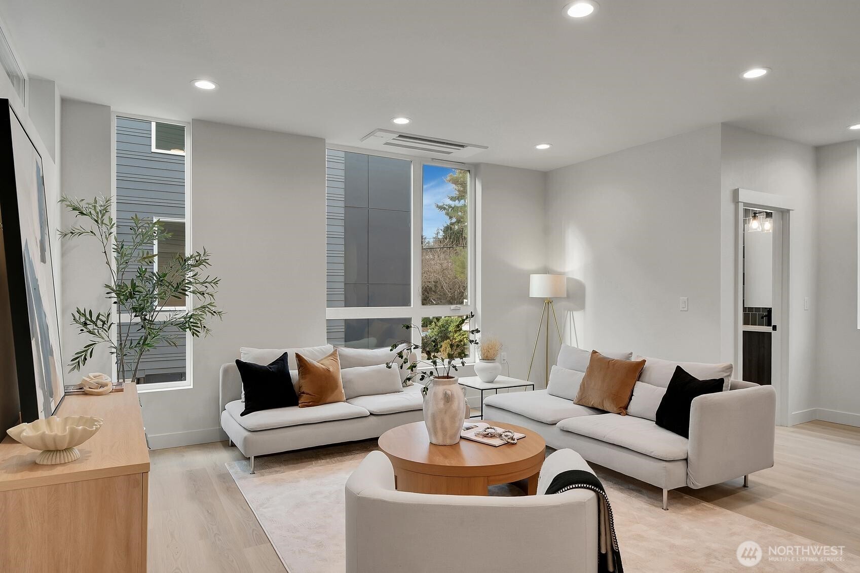 Wide open gourmet kitchen with ceiling height windows