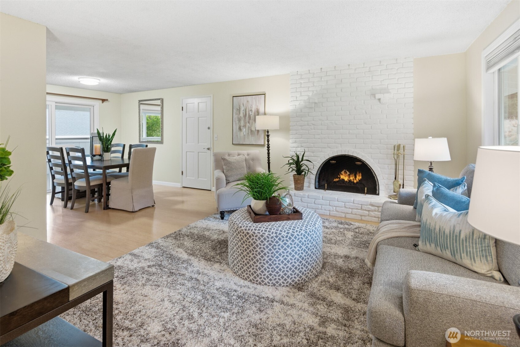 View from the front entry of the light and bright living room and dining room. The wood burning fireplace is gorgeous!