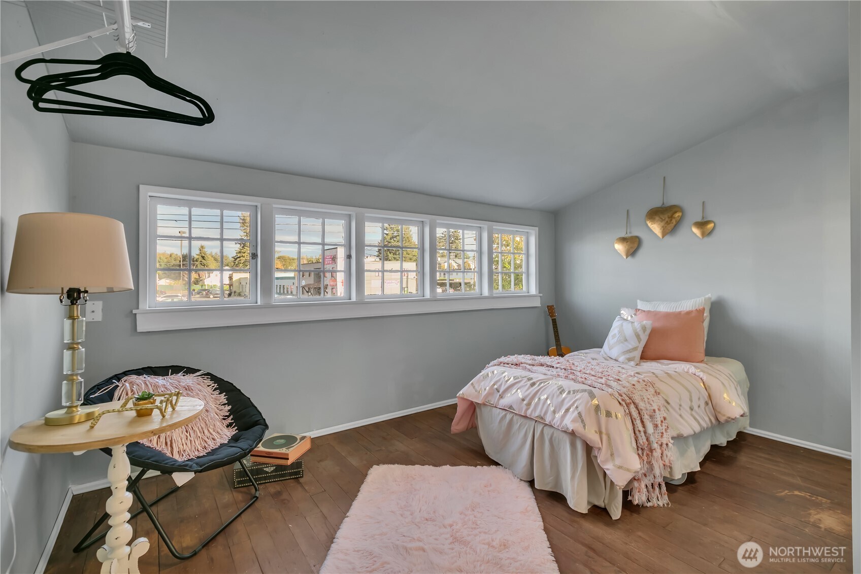 Upper-level bedroom with a wall of multi-pane windows.