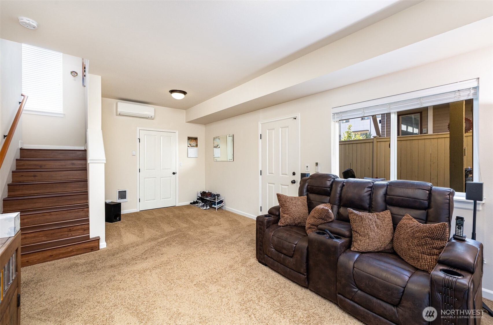 The lower level offers versatile space for an office, workout area, or second living room.