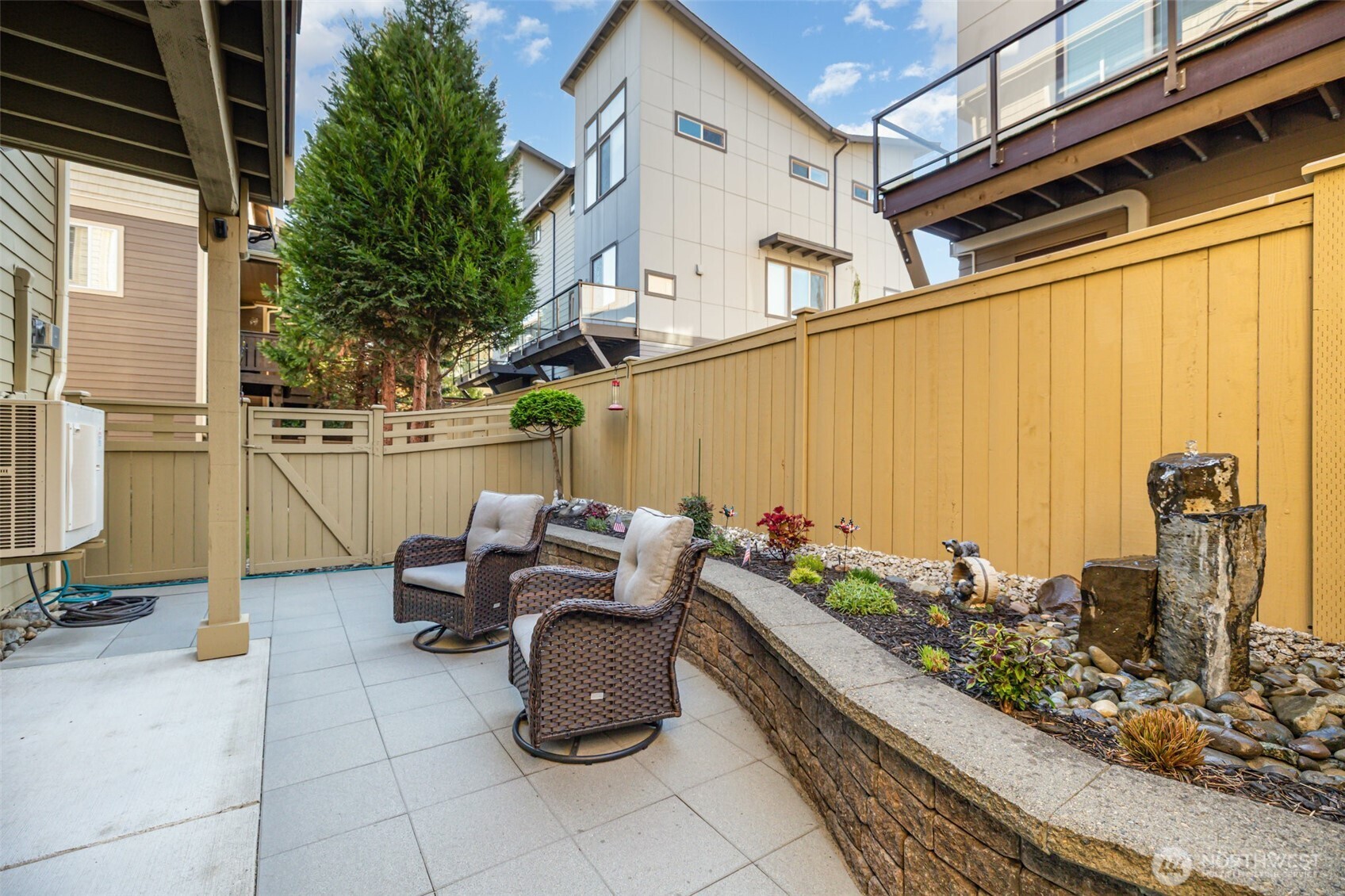 Low-maintenance private yard is perfect for relaxing with functional water bubbler.