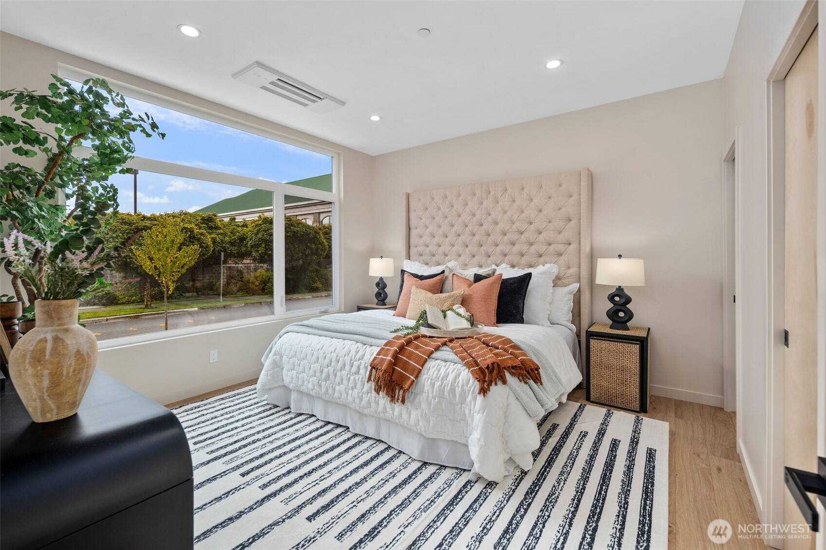 Main floor-spacious primary bedroom with ensuite bathroom and walk-in closet.