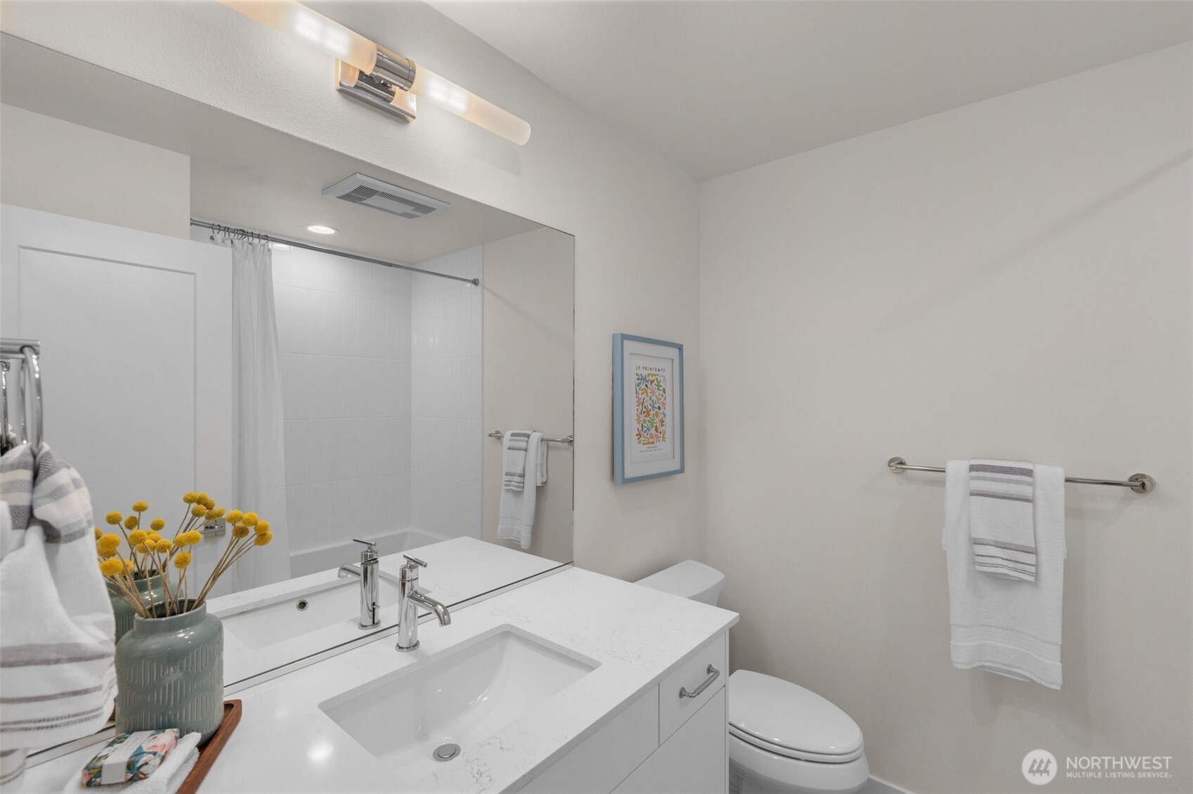 Full bathroom with chic tilework and spacious vanity offers a calm spa-inspired feel.